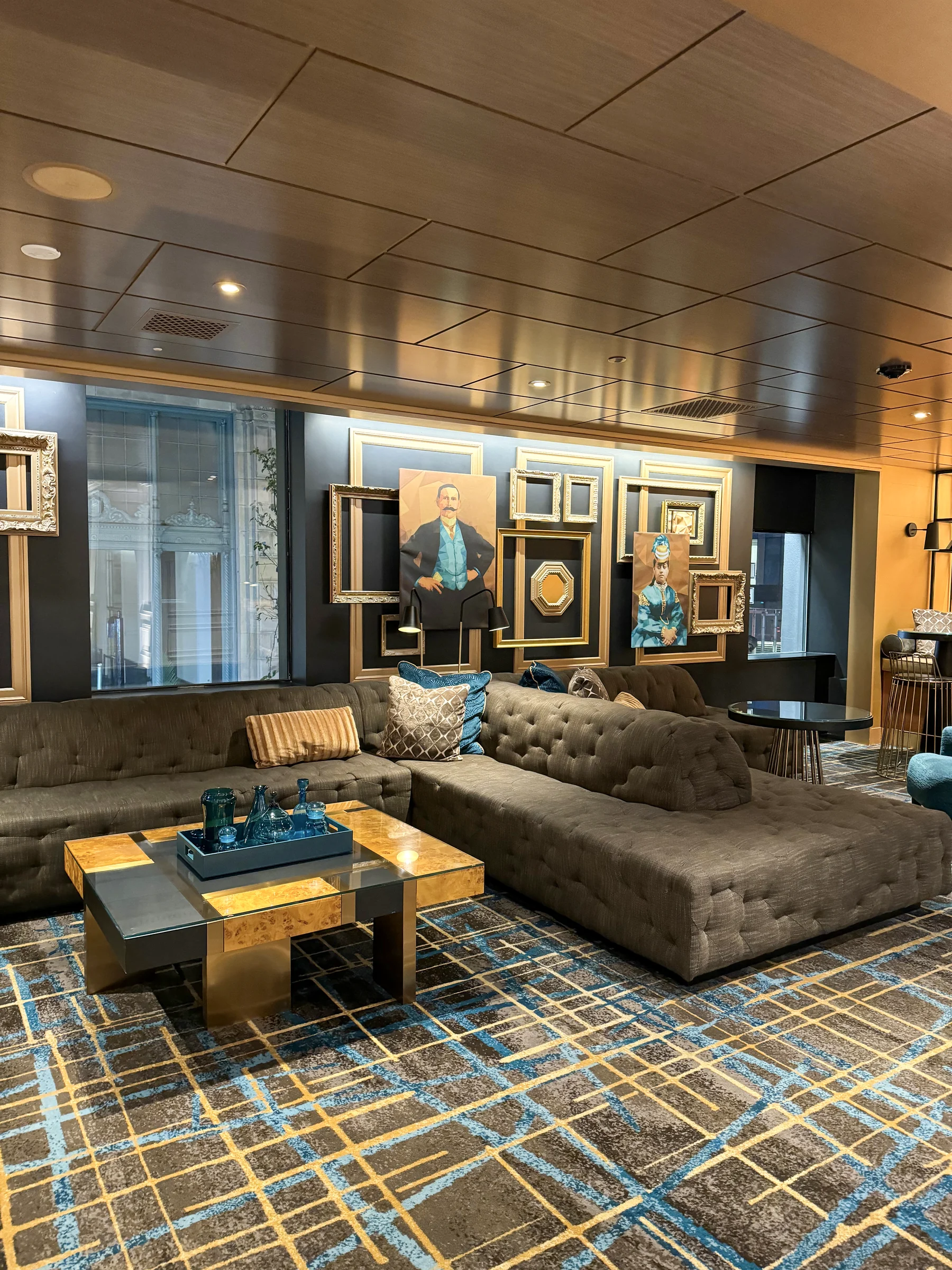 A lobby with a wooden ceiling and blue carpet.