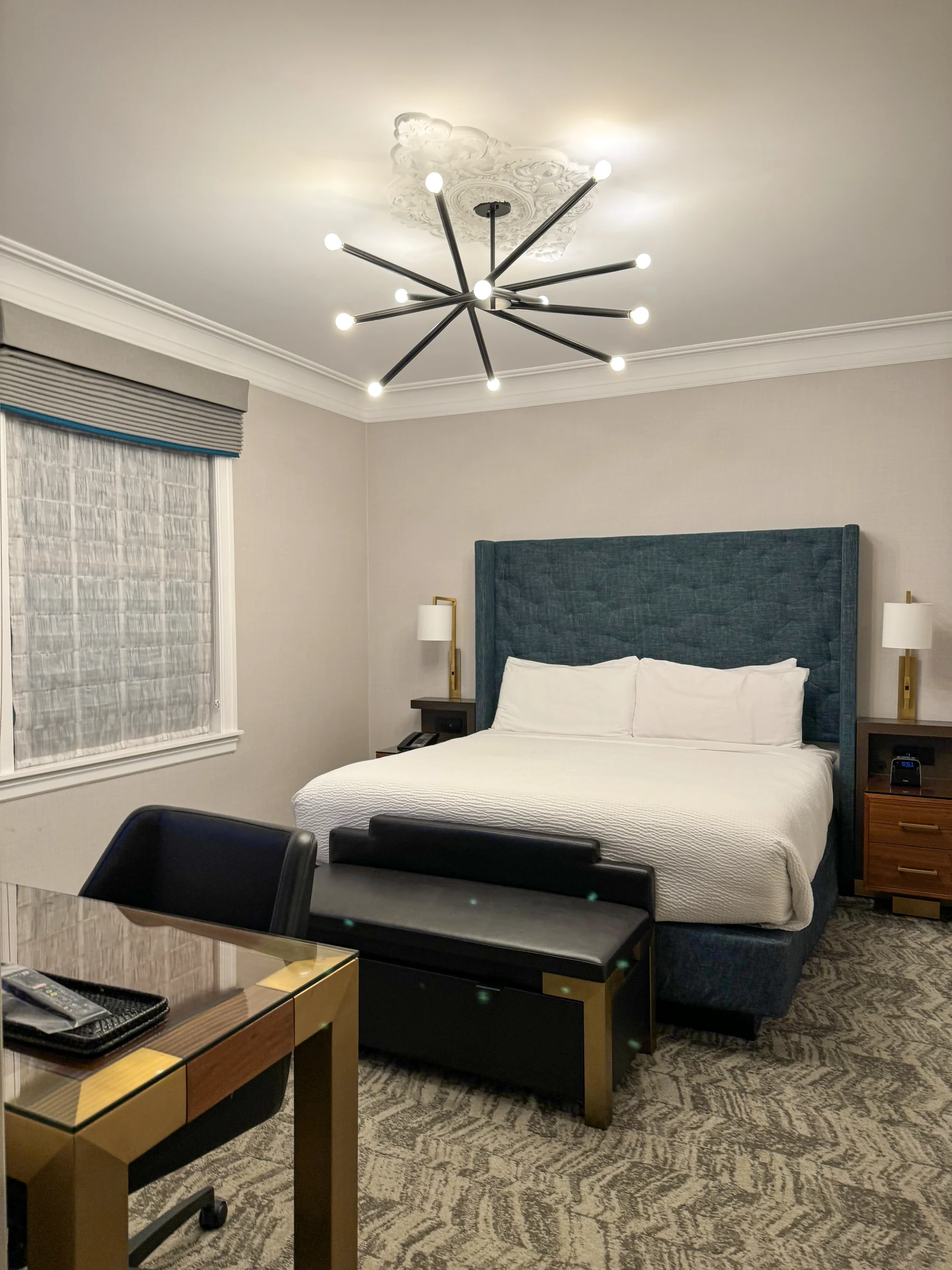 A room at Courtyard San Francisco on Van Ness Avenue, with a blue headboard and distinctive lighting
