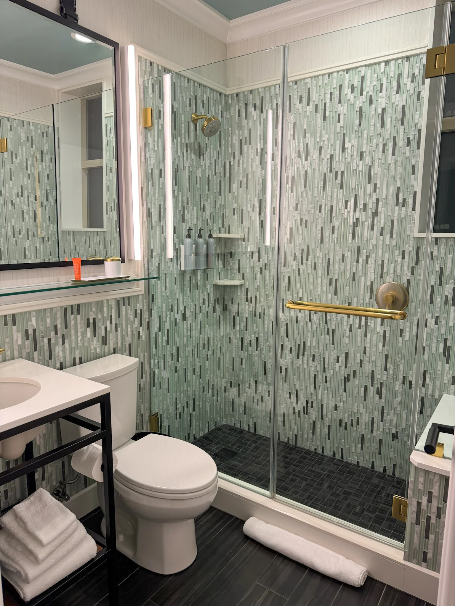 Tiles and gold fittings in the shower room.