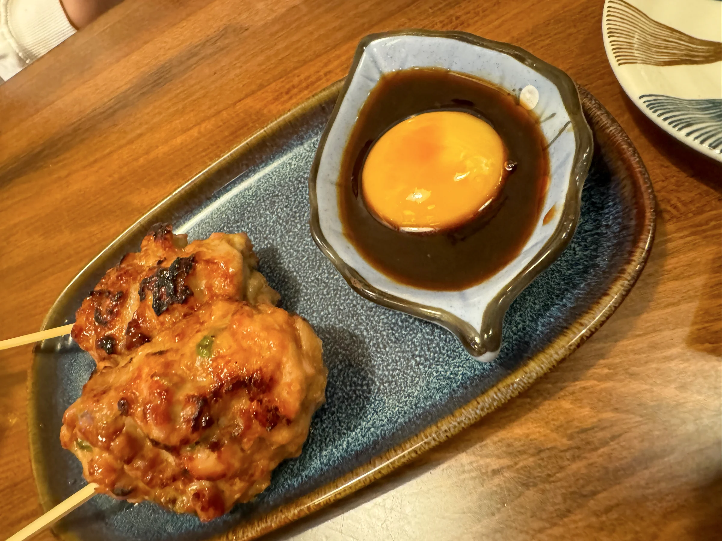 Tsukune served with an egg yolk.