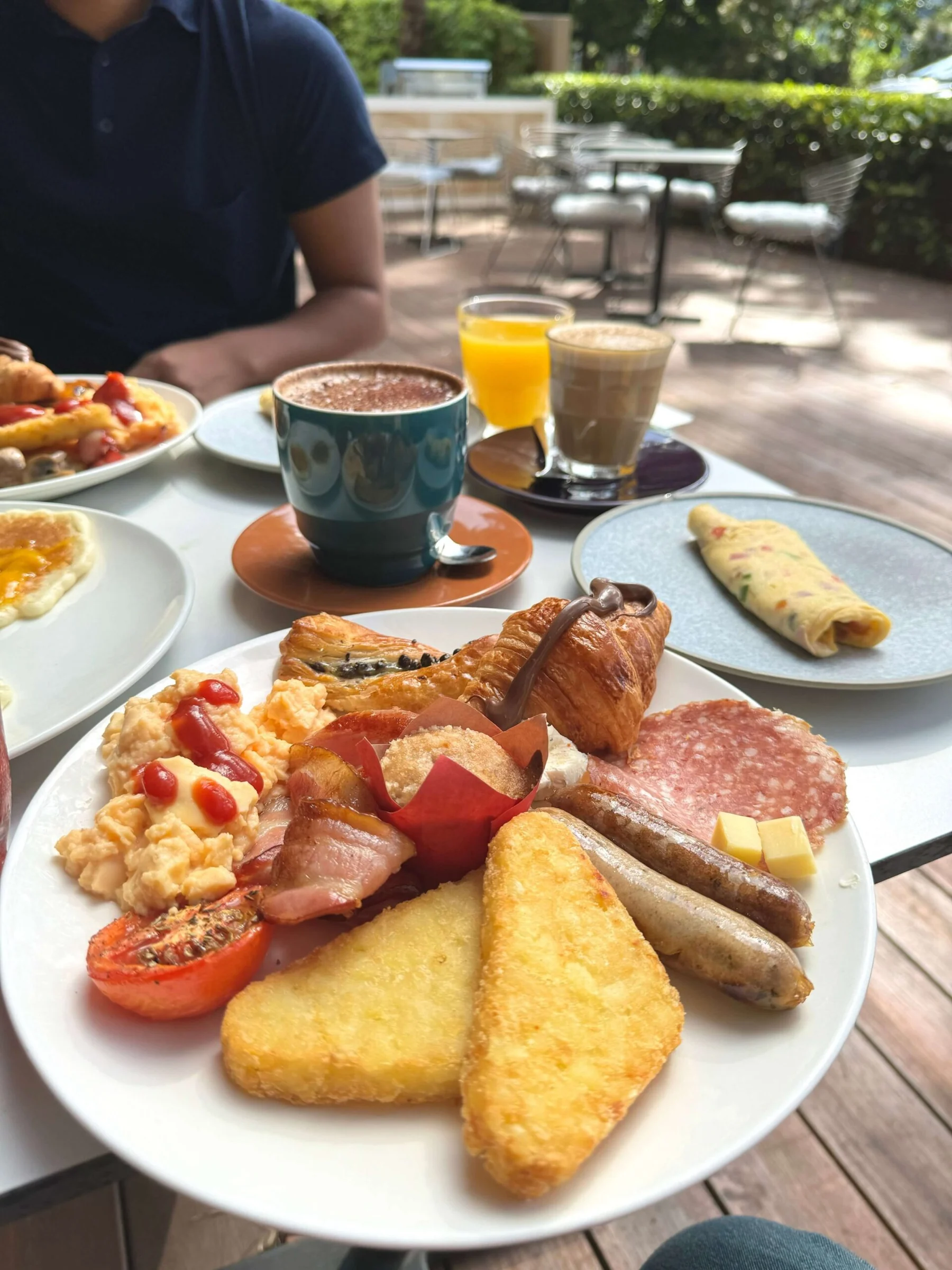 Breakfast on a terrace surrounded by greenery.