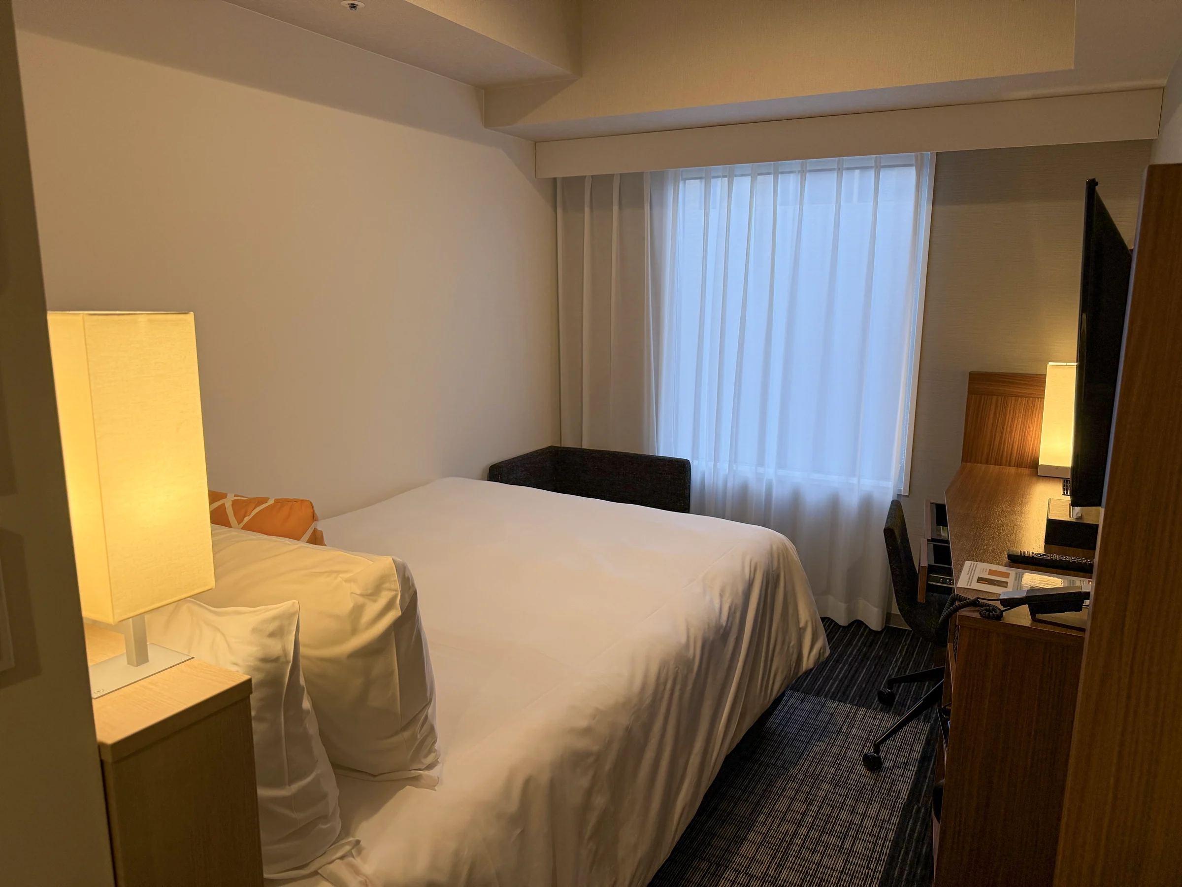 The double bed by the window.