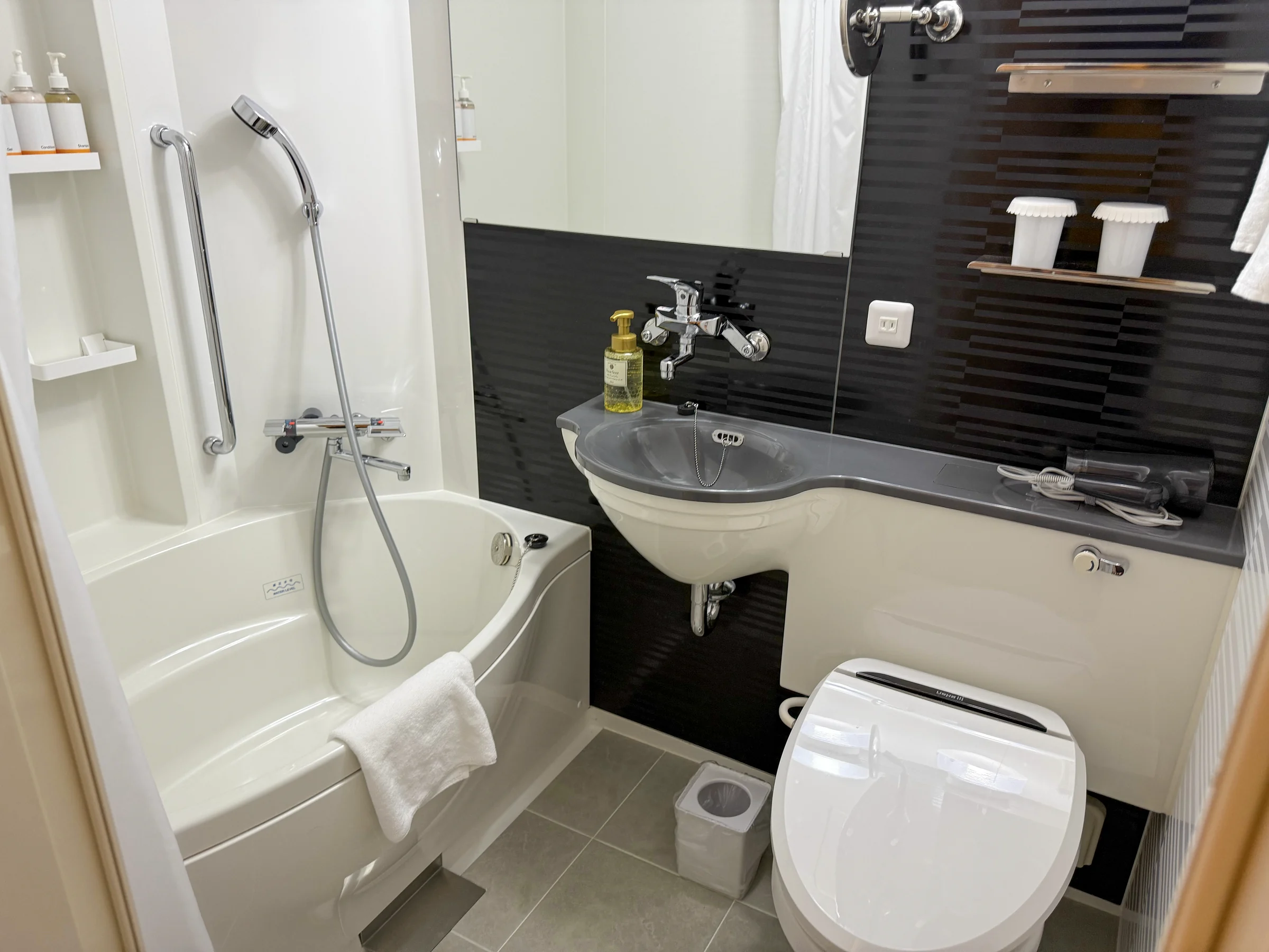 The combined bathroom with a bathtub.