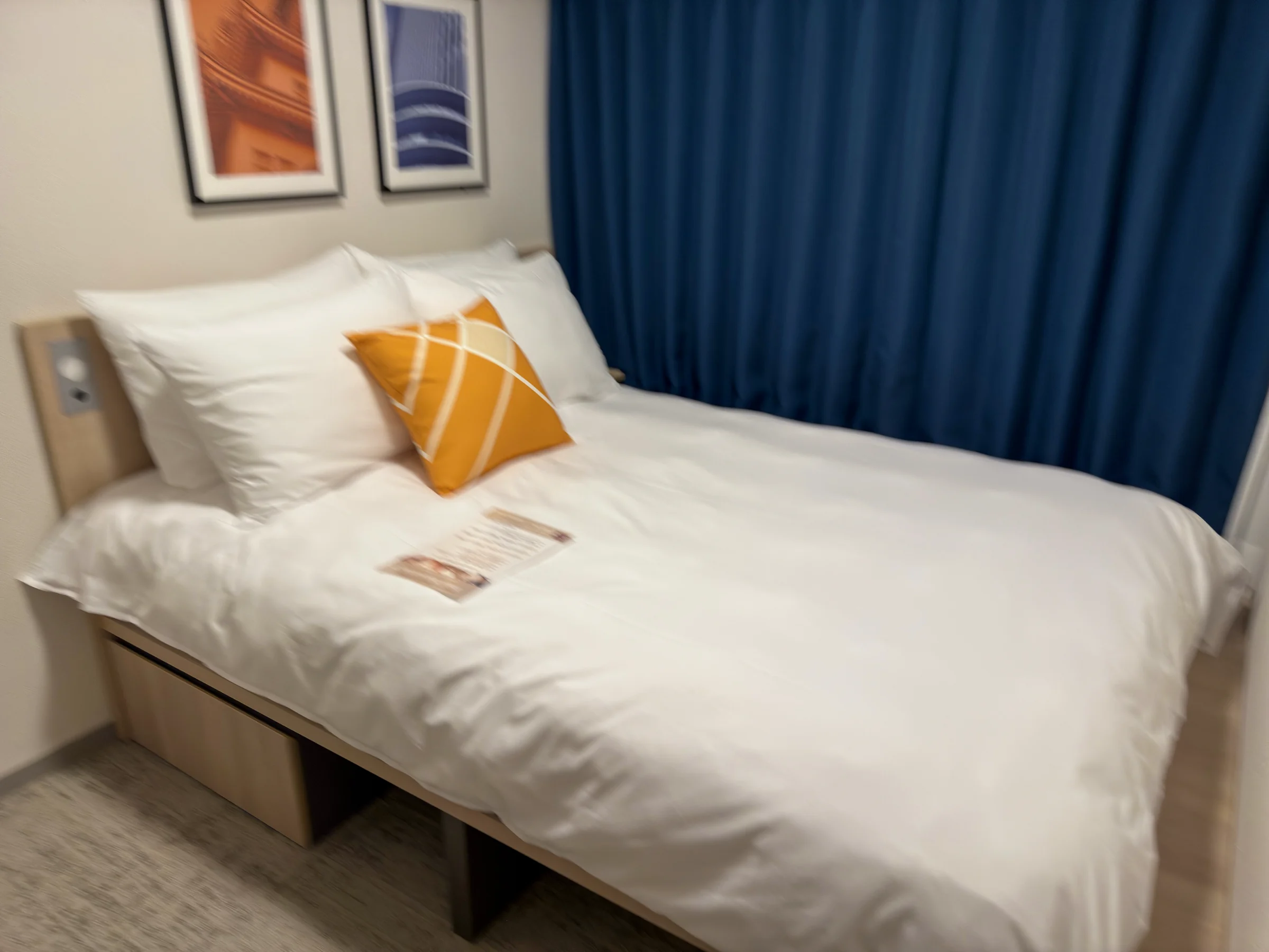 Blue curtains and orange cushions.