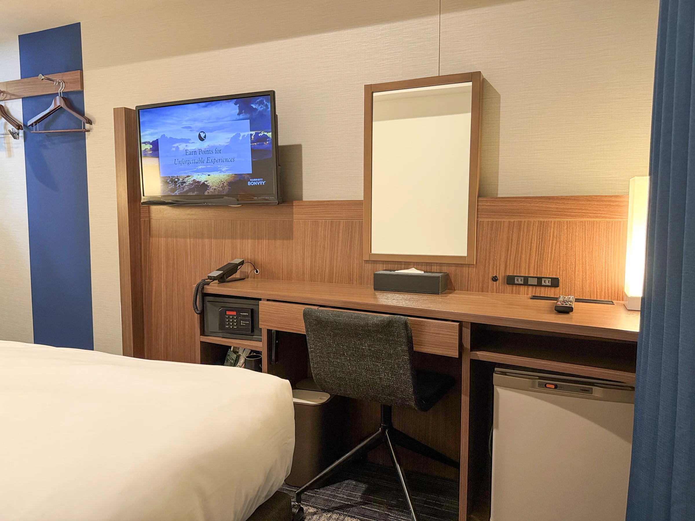 The desk and TV opposite the bed.