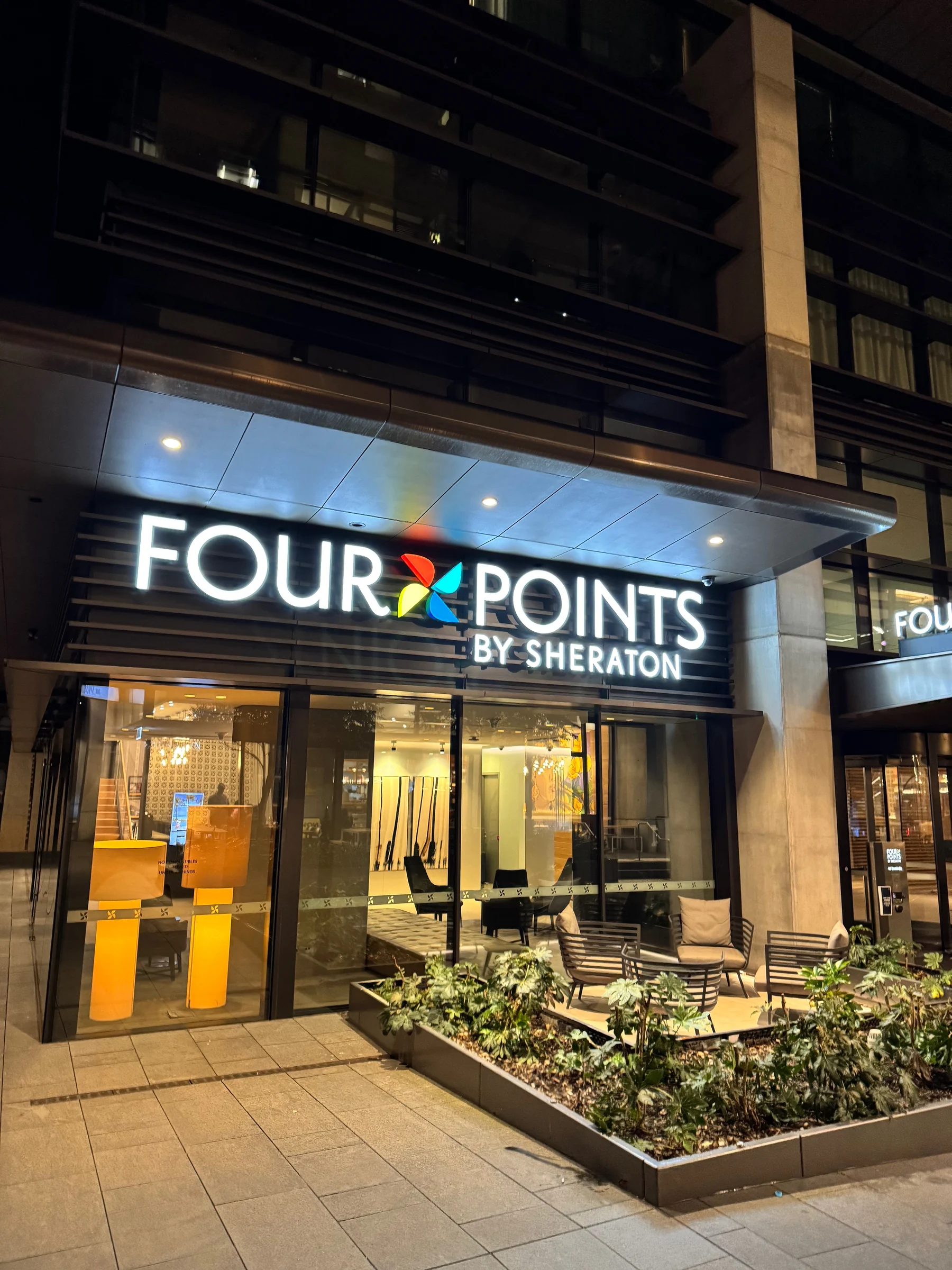 The hotel logo lights up brightly at night.