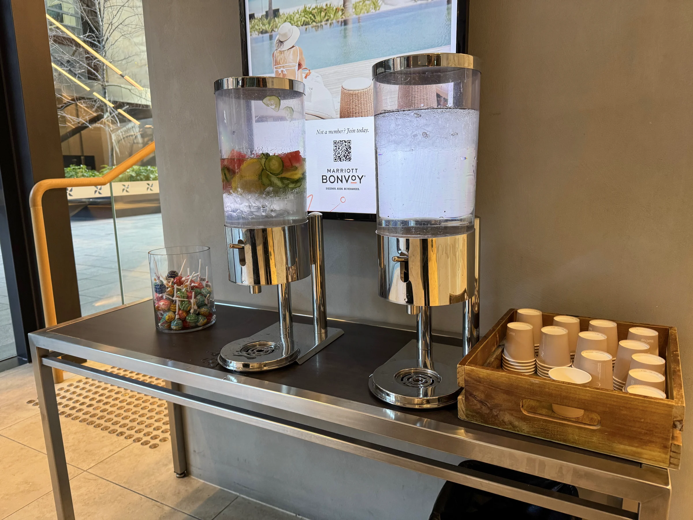 A station with fruit-infused water and cups.