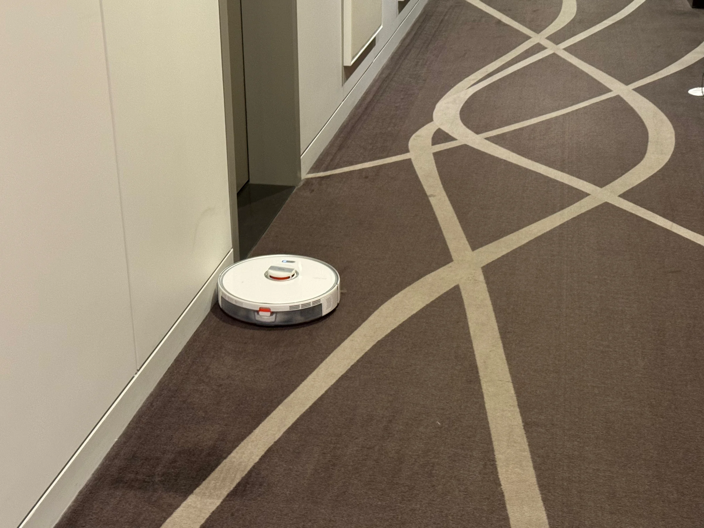 A cleaning robot in the corridor.