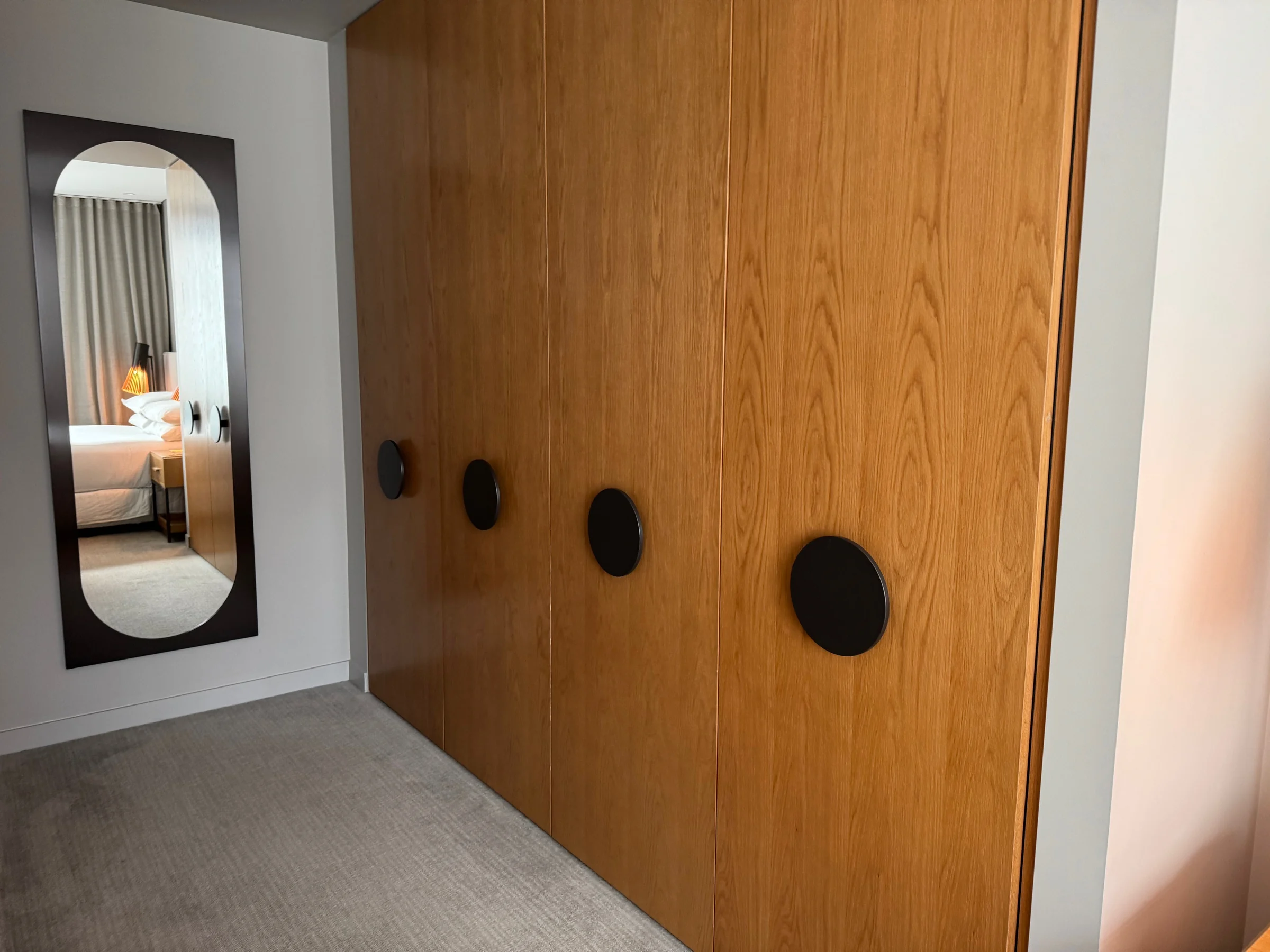 The area with a wardrobe and full-length mirror.