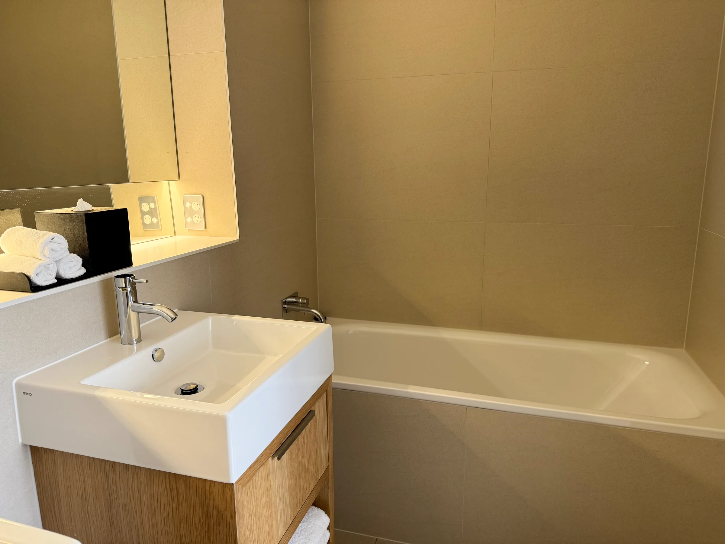The bathtub beside the vanity.