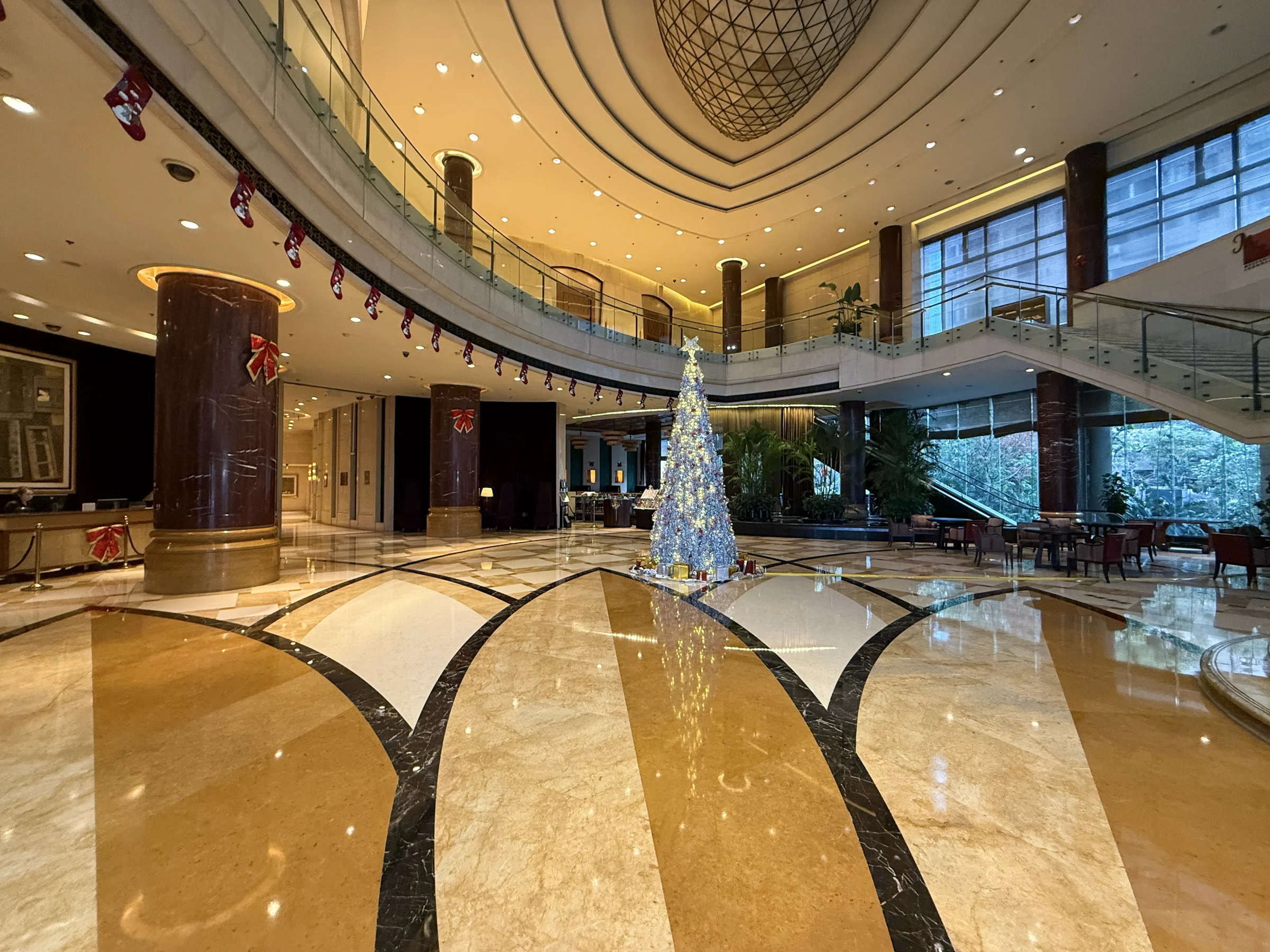 A double-height lobby with Christmas decorations.