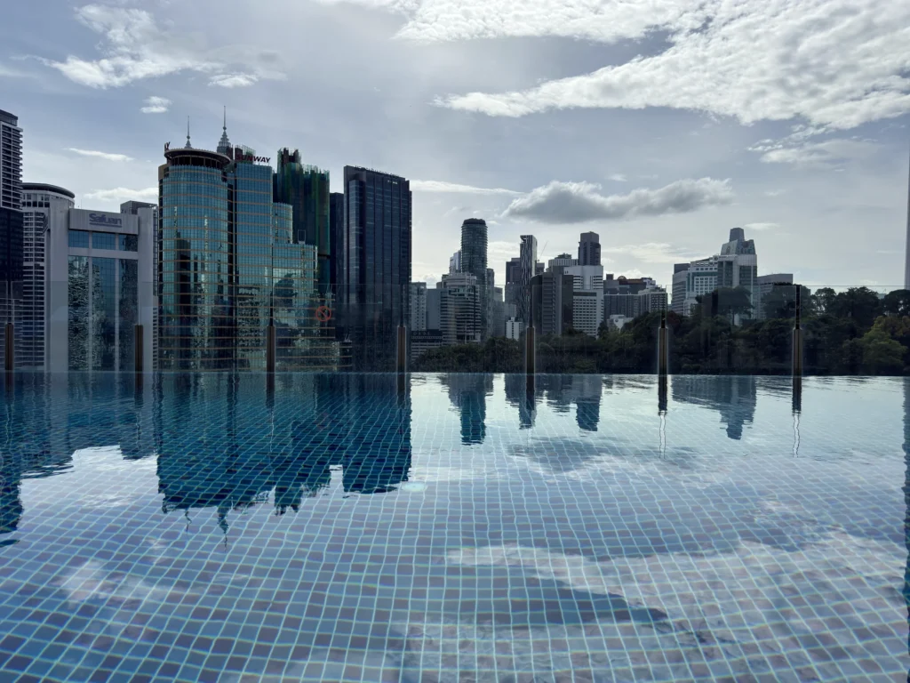 Hotel Stripes Kuala Lumpurの屋上インフィニティプールと、水面に映る街並み