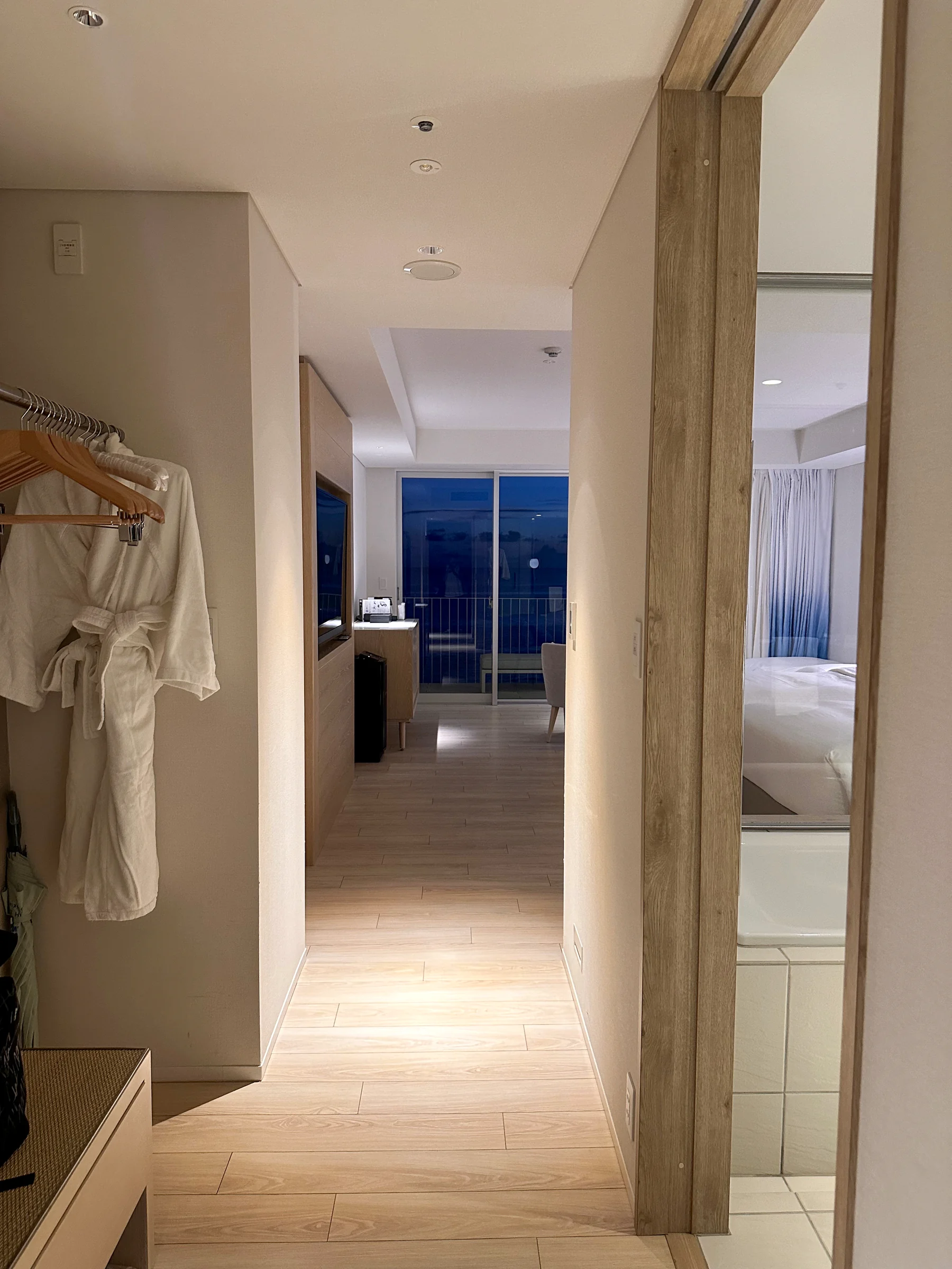 A white corridor leading to the room.