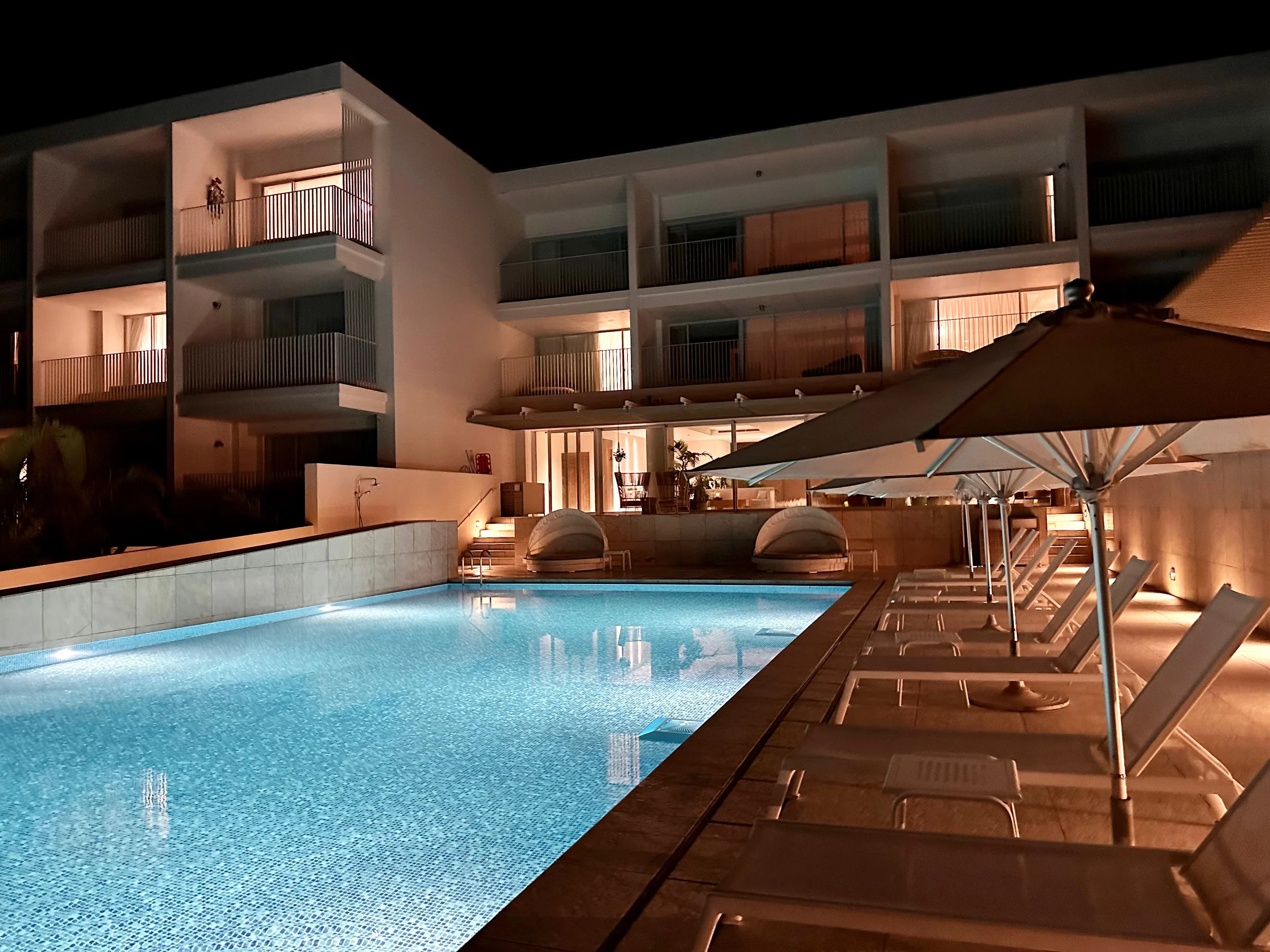 The illuminated pool at night.