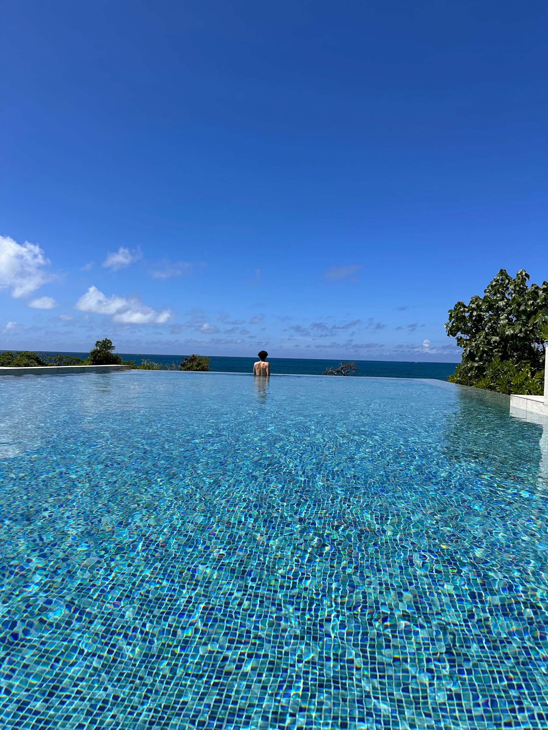 Blue sea beyond the pool.