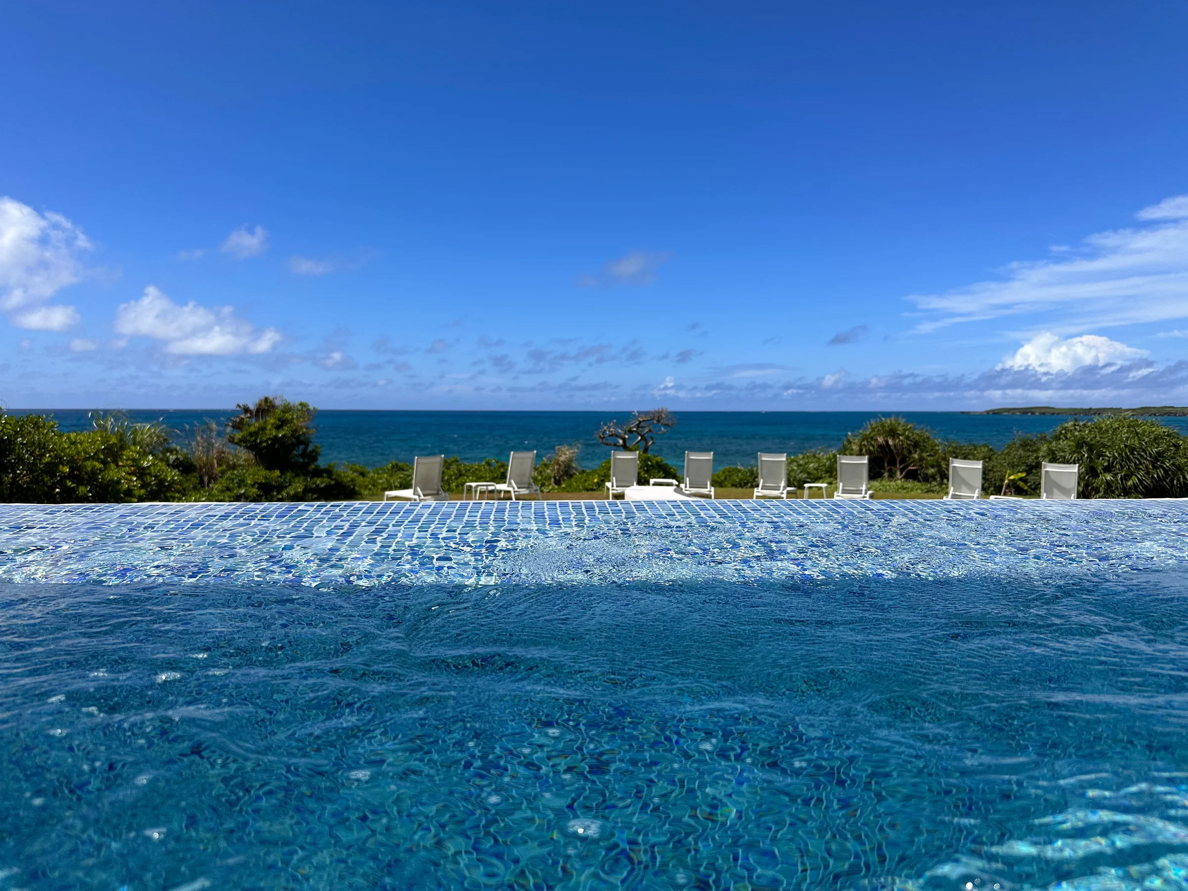 The pool and blue sea beyond at IRAPH SUI Miyako Okinawa