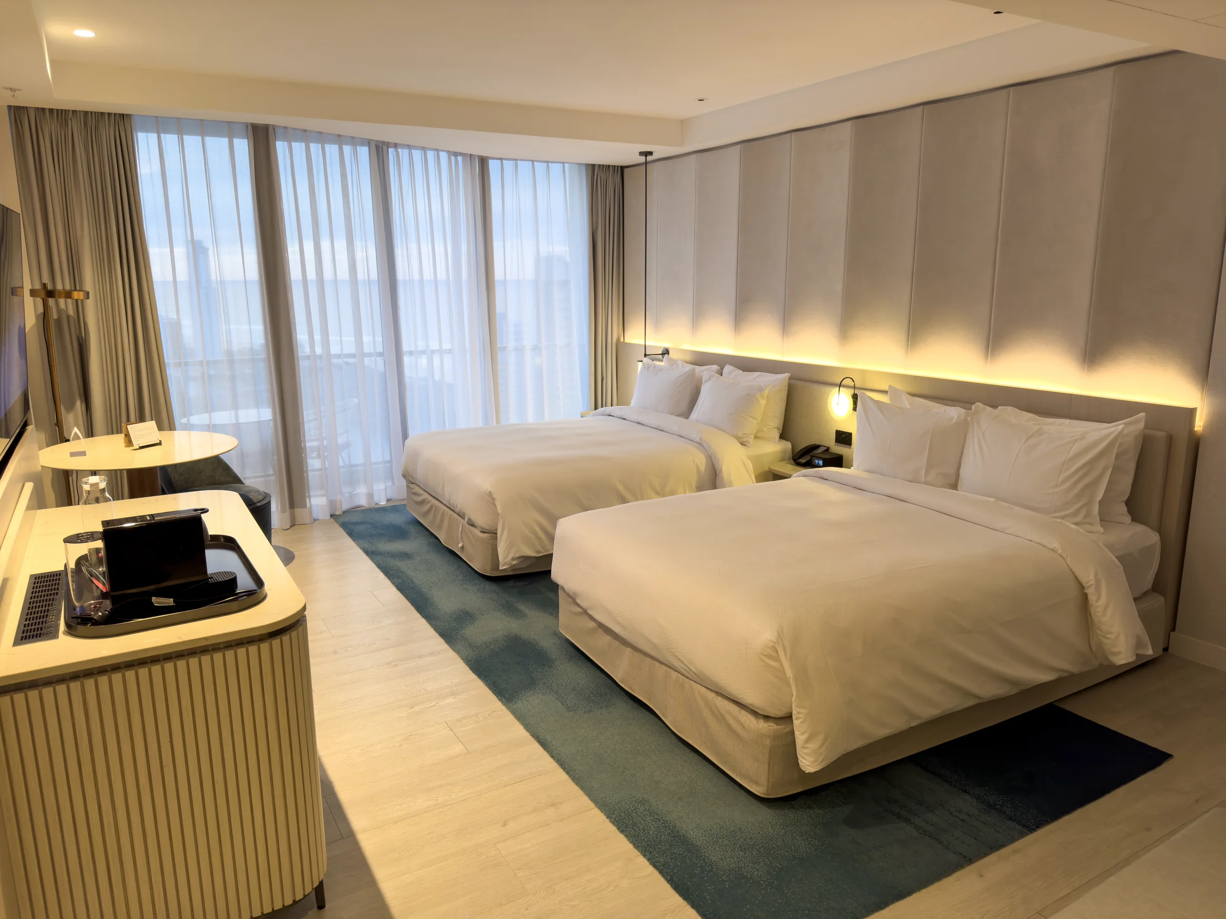 An ocean-view room with two double beds.