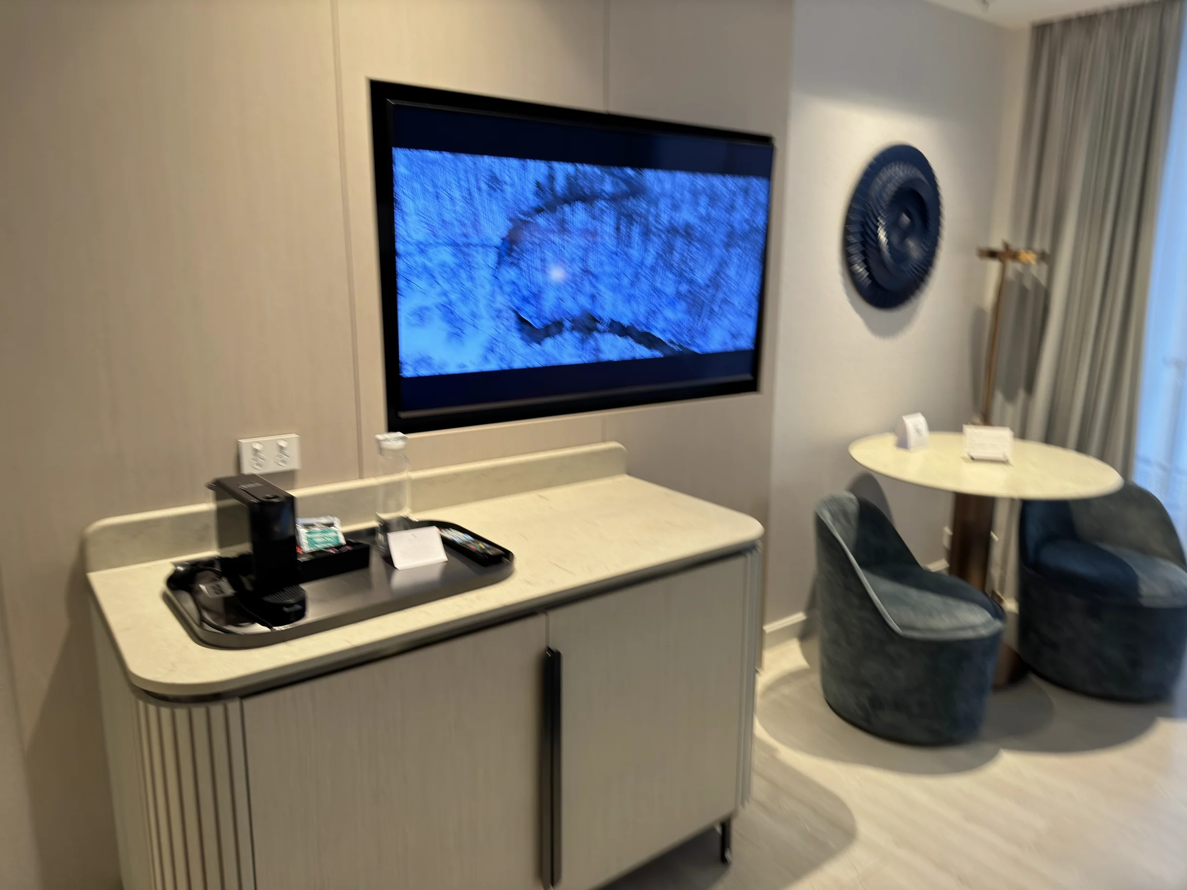 A corner with the TV and round table.