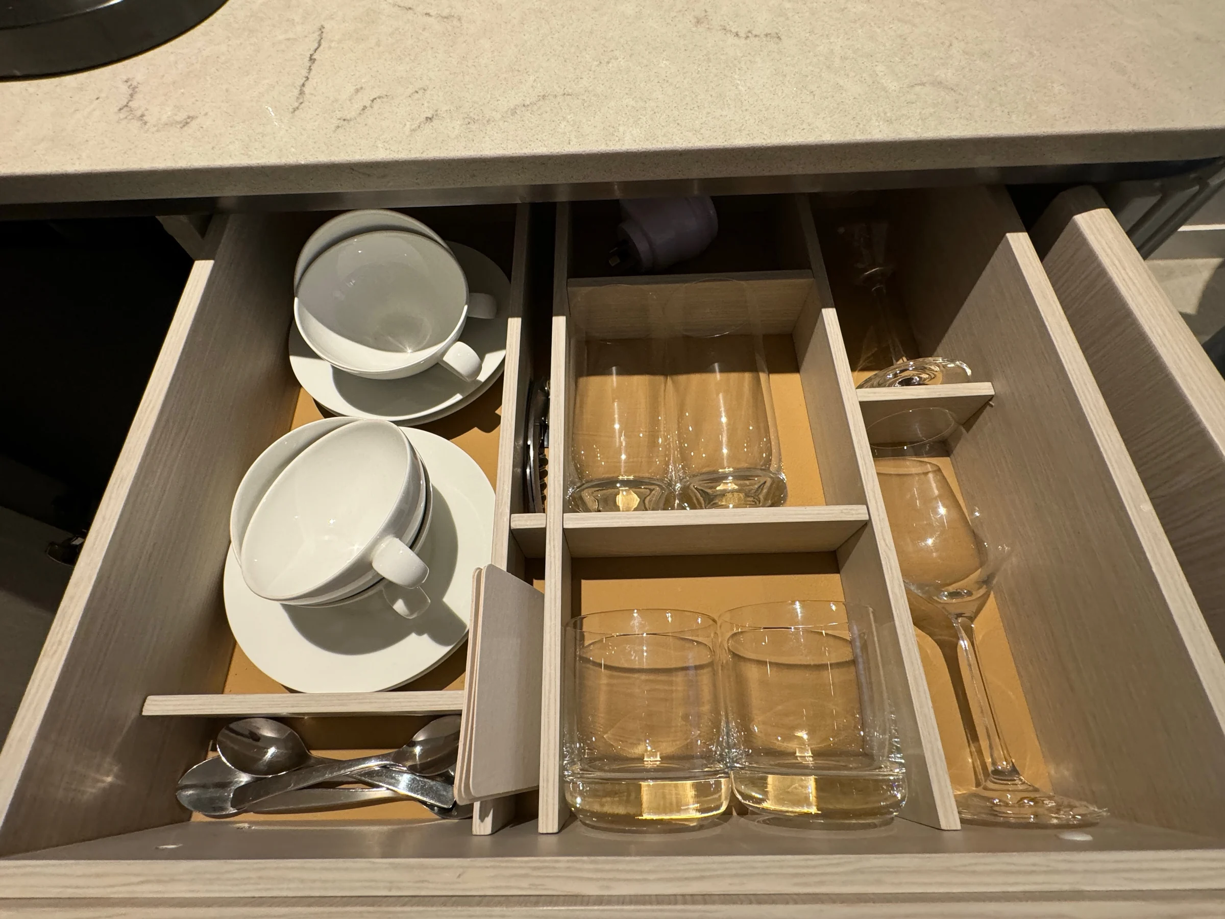 Cups and glasses in the drawer.