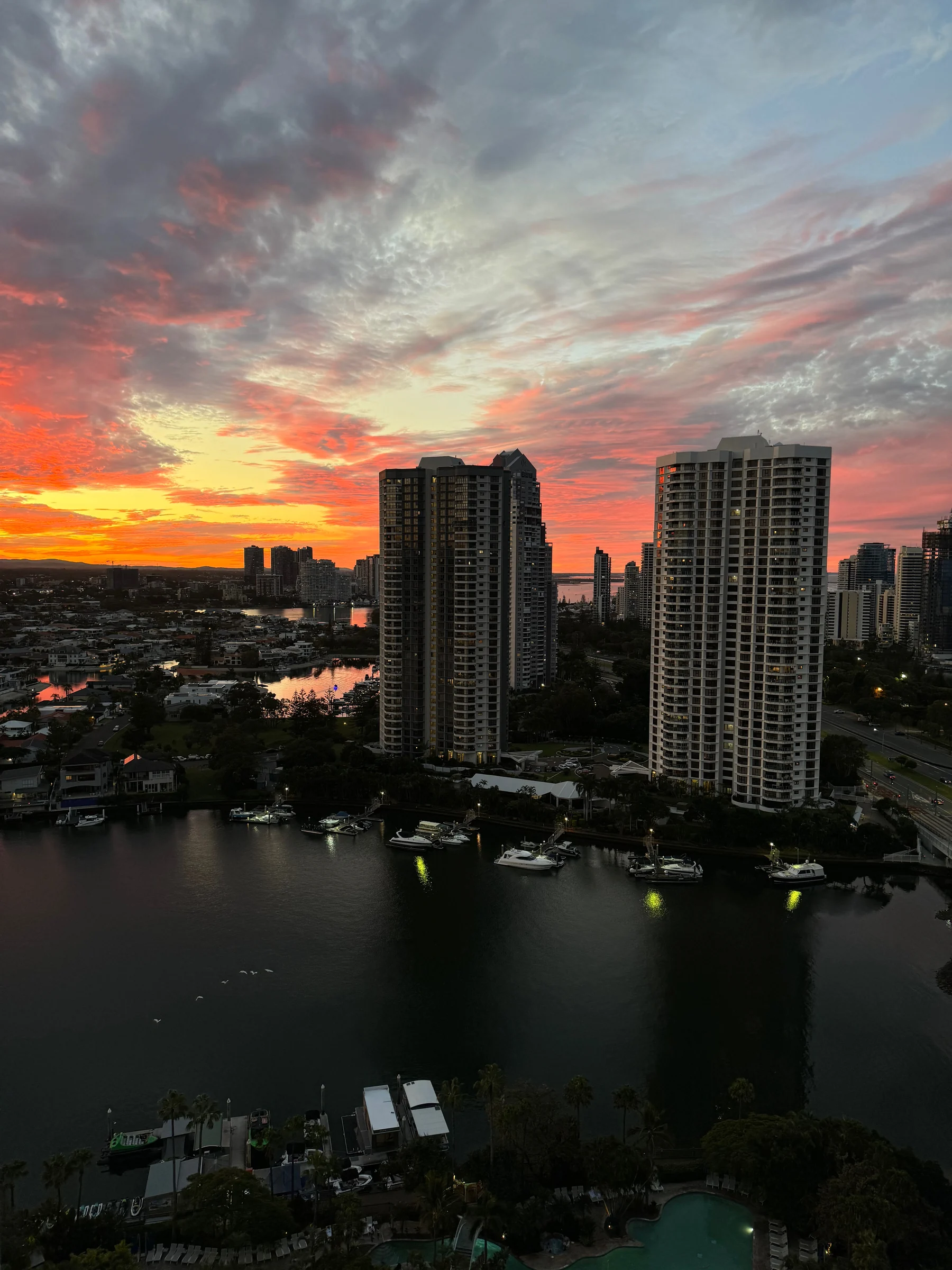 Vivid orange beneath the clouds as the sun sets.