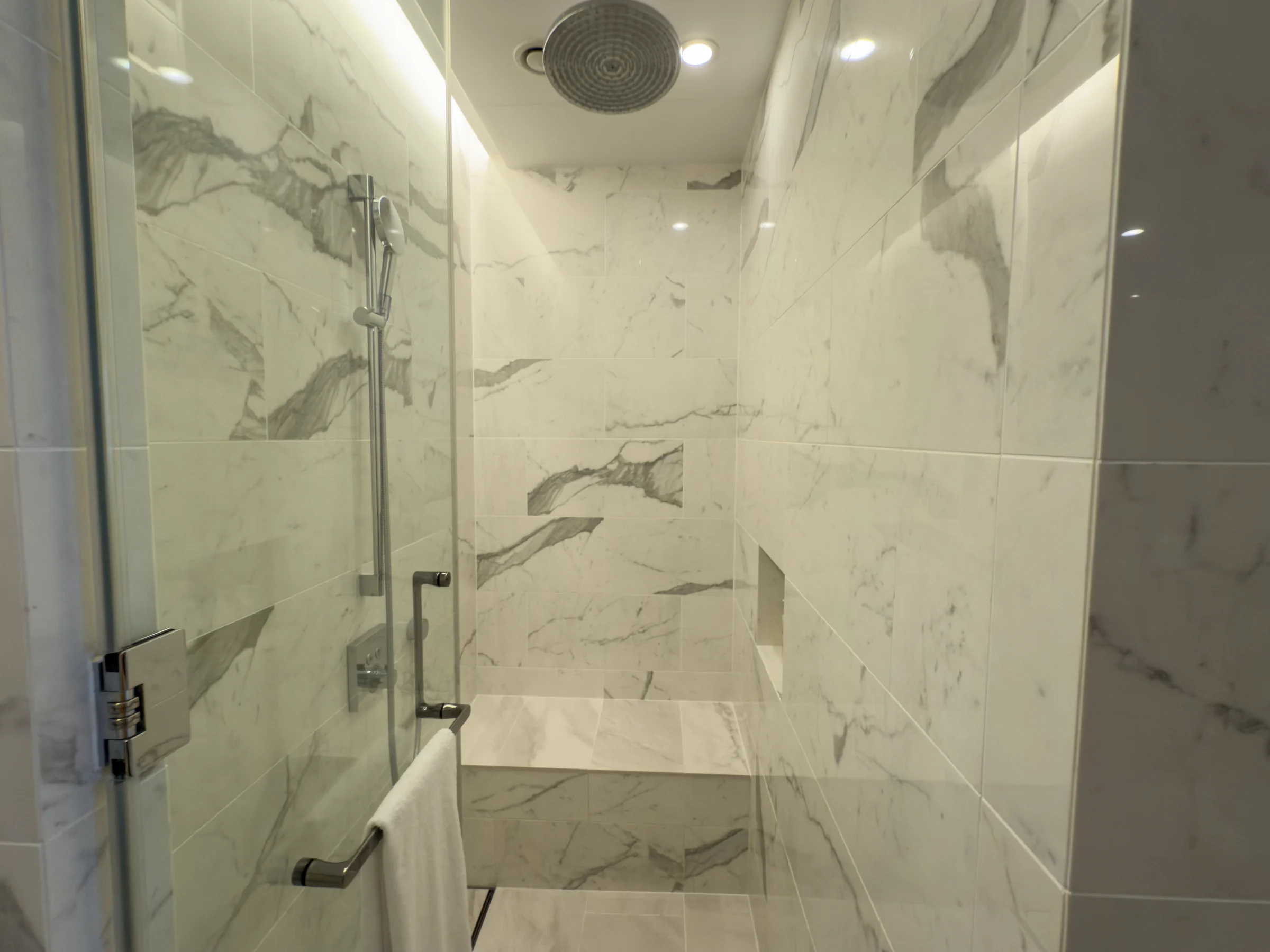 A shower cubicle with a seat.