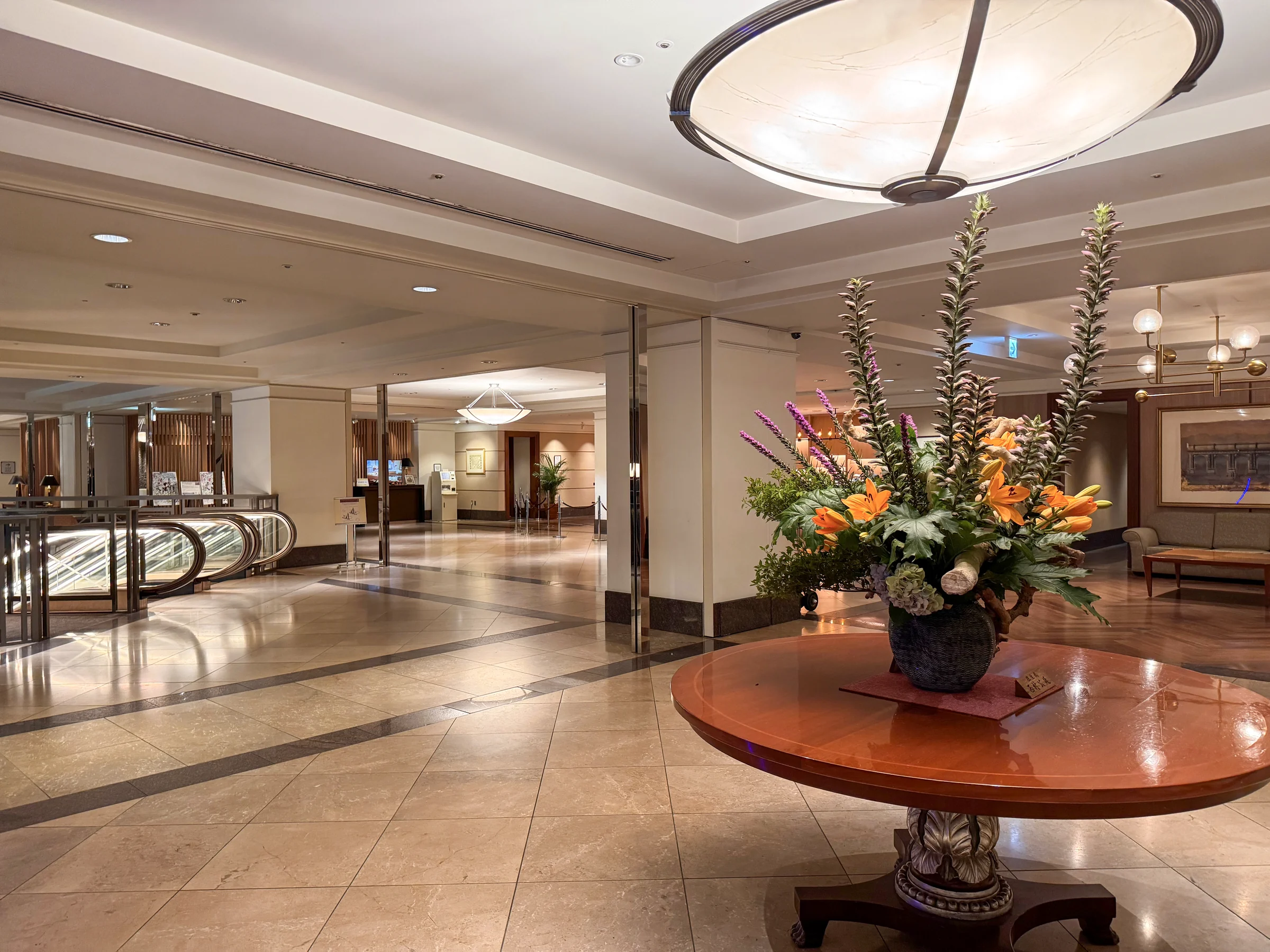 A curved ceiling and flowers in the lobby.