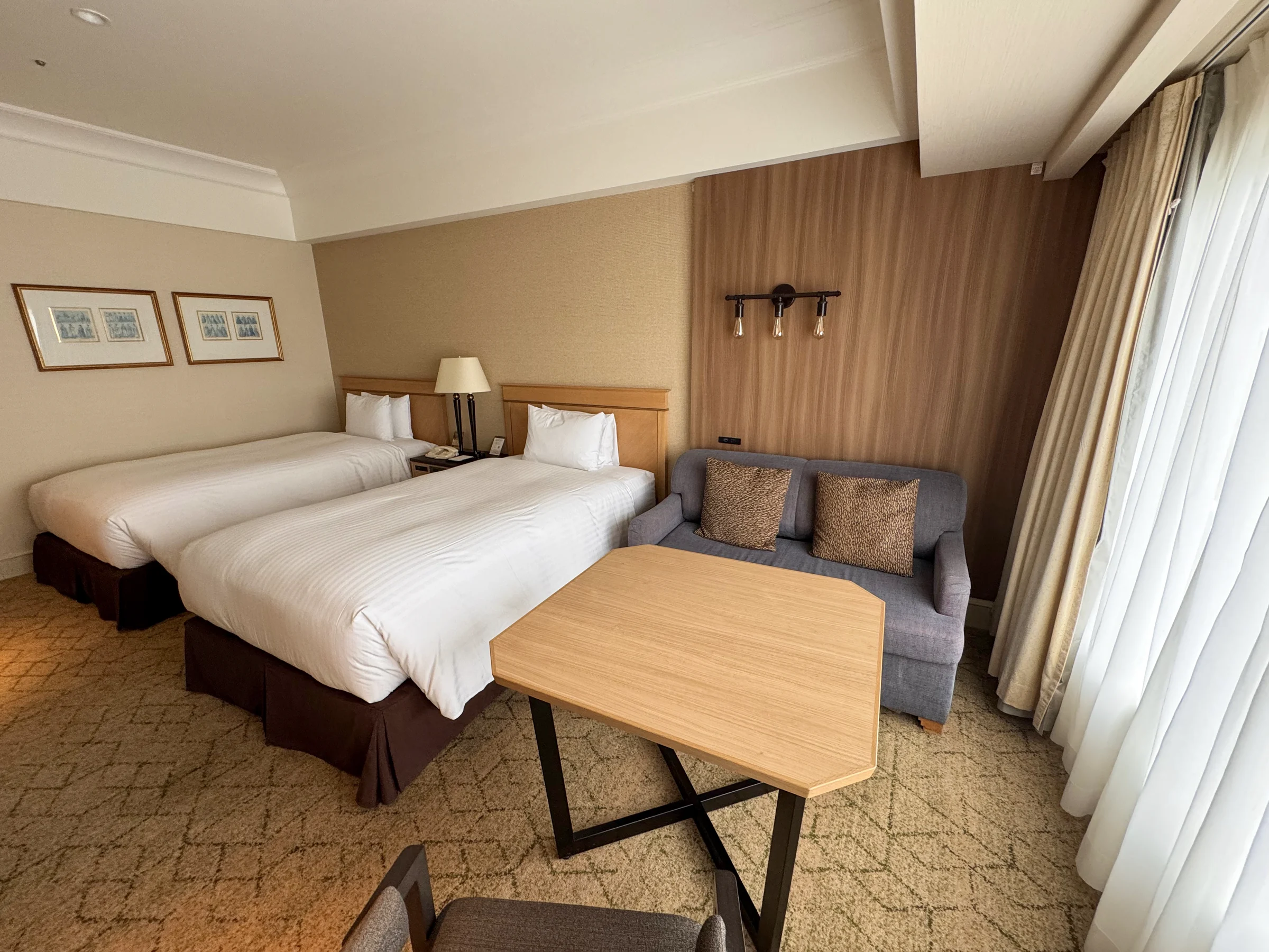 The twin room at Kobe Bay Sheraton, with beds, window-side chairs and a round table