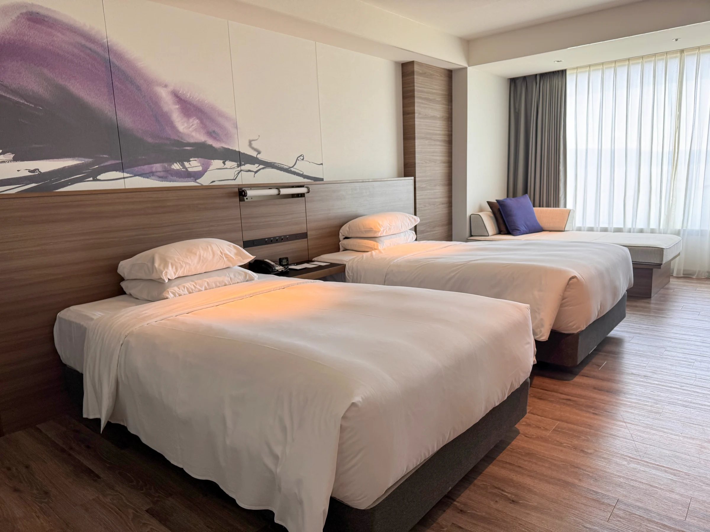 Lake Biwa Marriott's twin room, with purple artwork, two beds and windows facing the lake