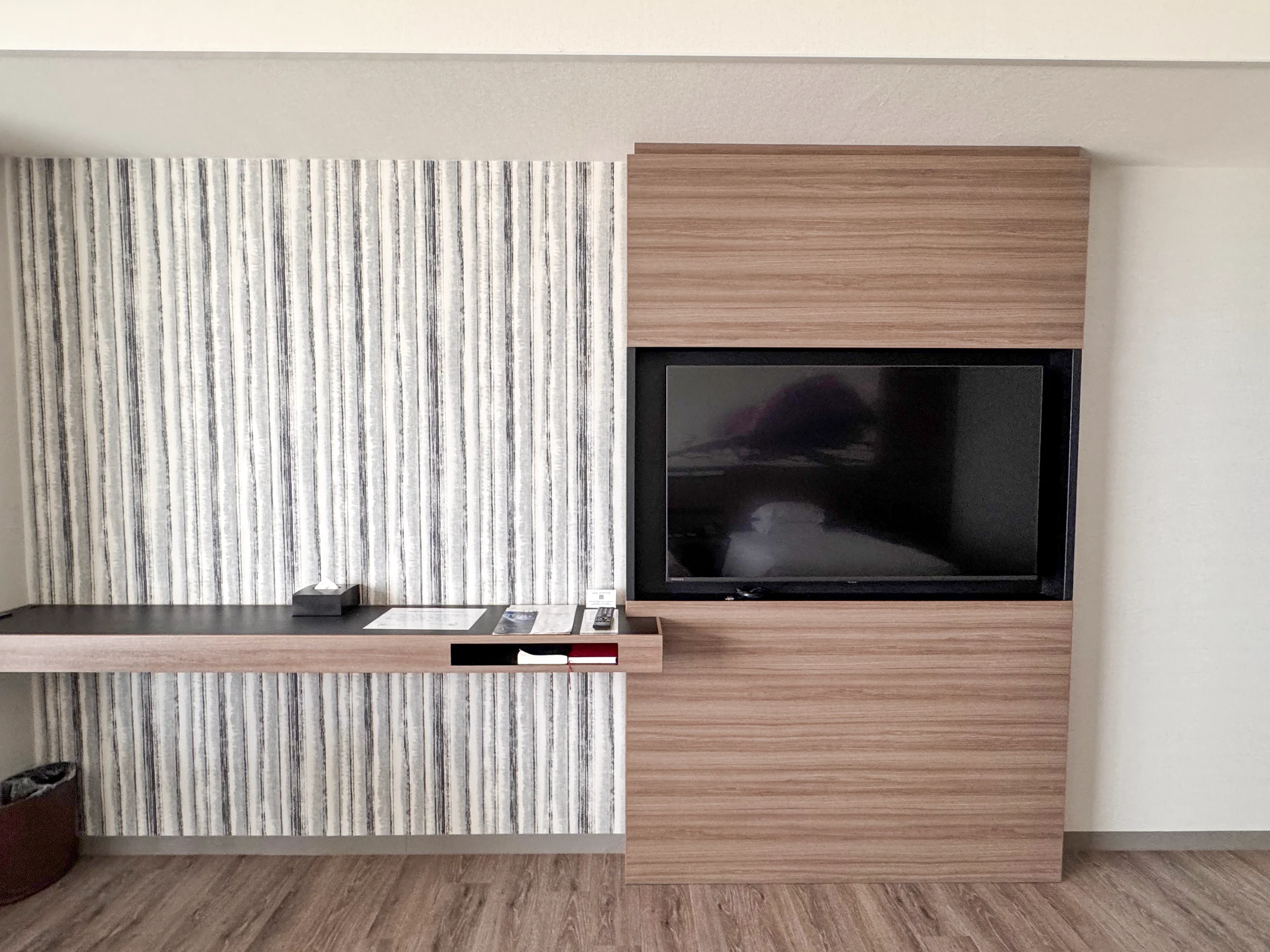 The room's large television and wood-grain wall