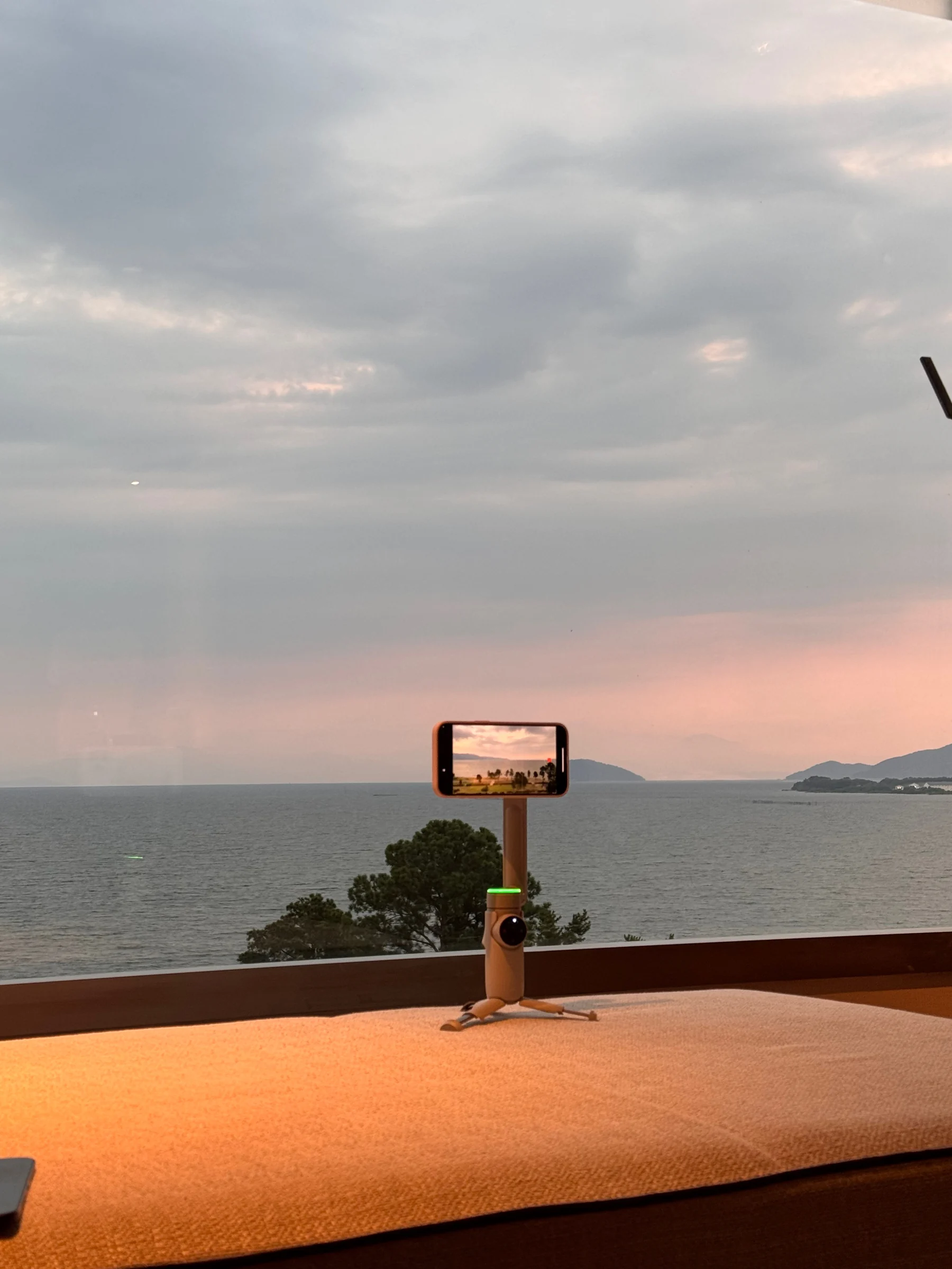 By the window overlooking the lake at dusk