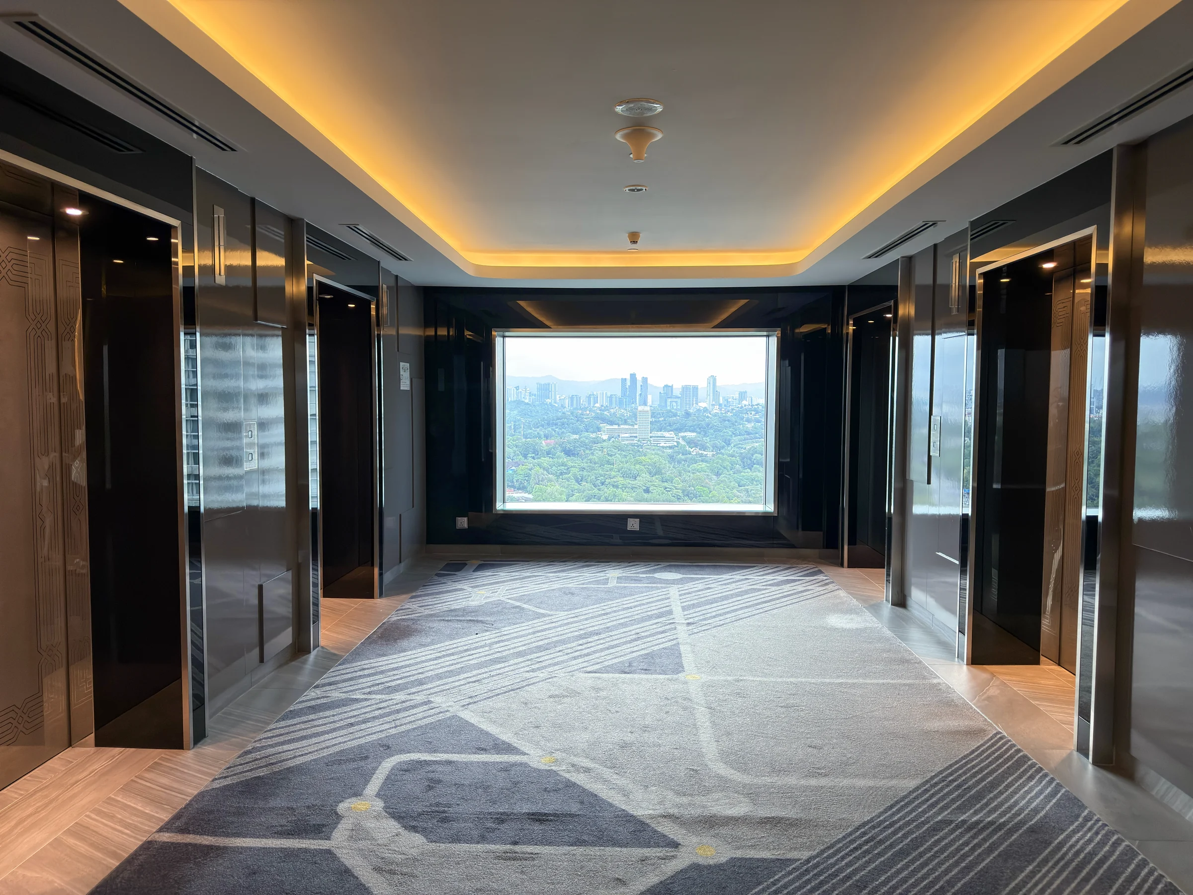 The elevator hall with large windows.