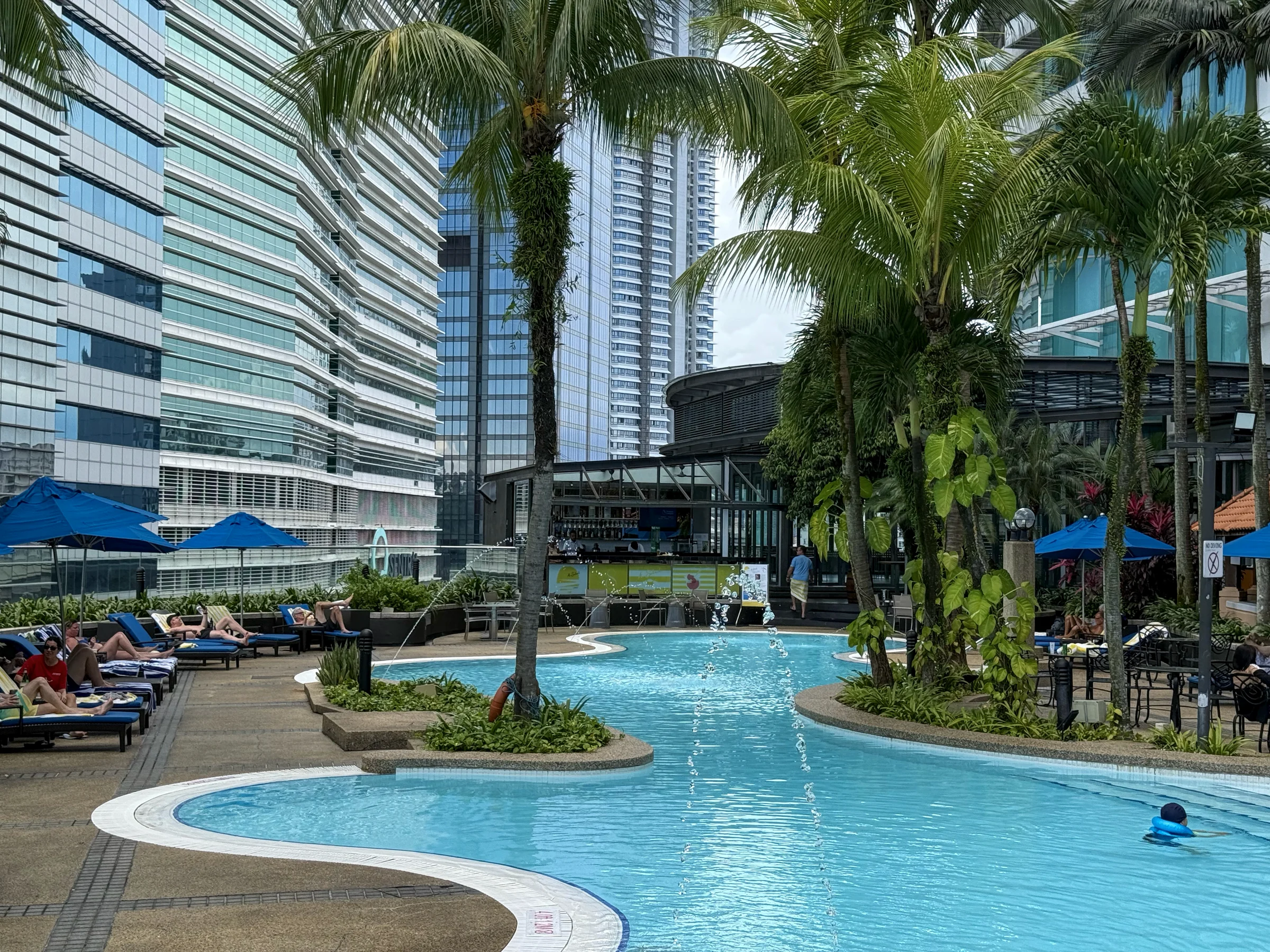 A large outdoor pool surrounded by skyscrapers.