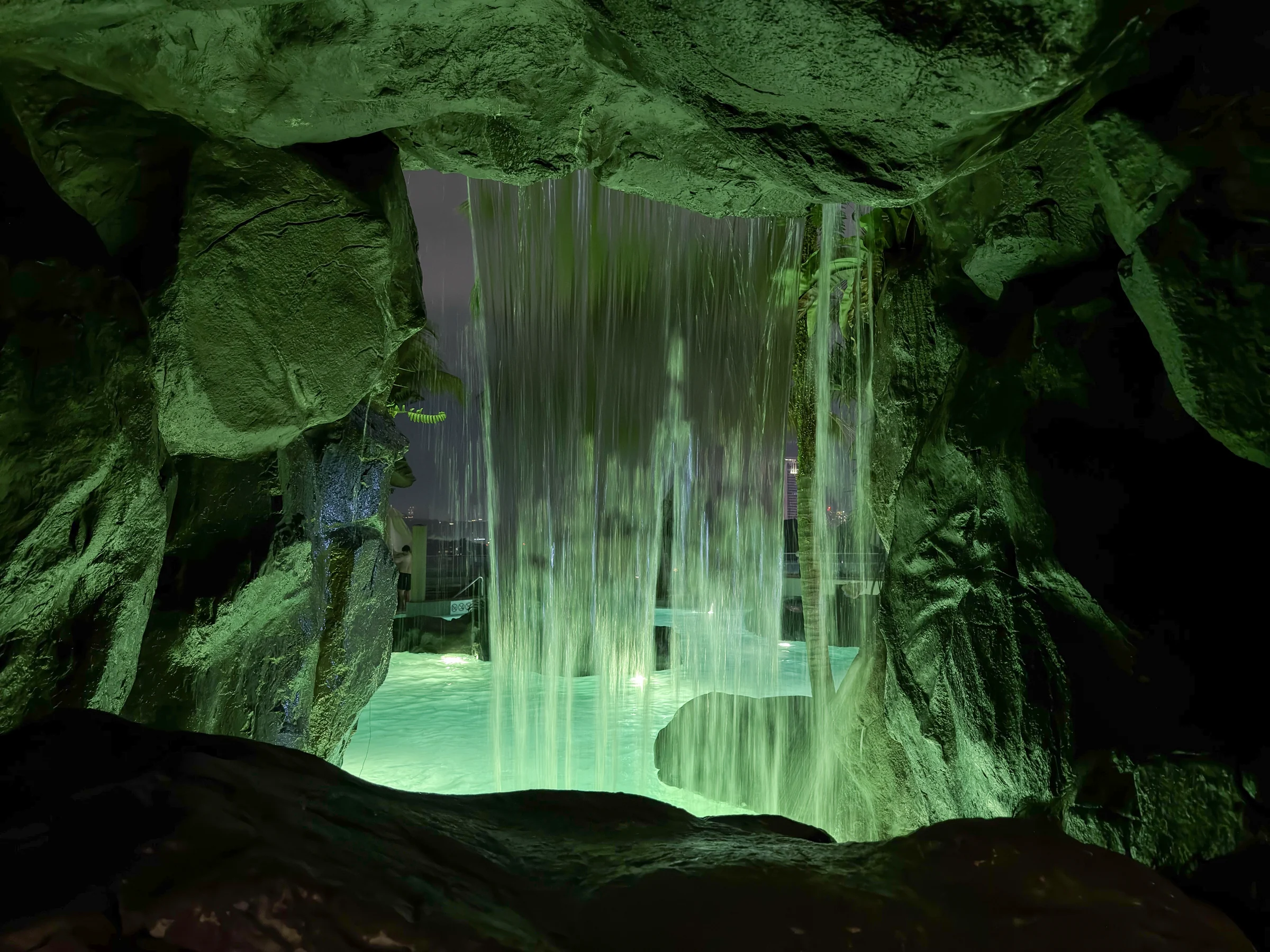 The waterfall, illuminated at night.