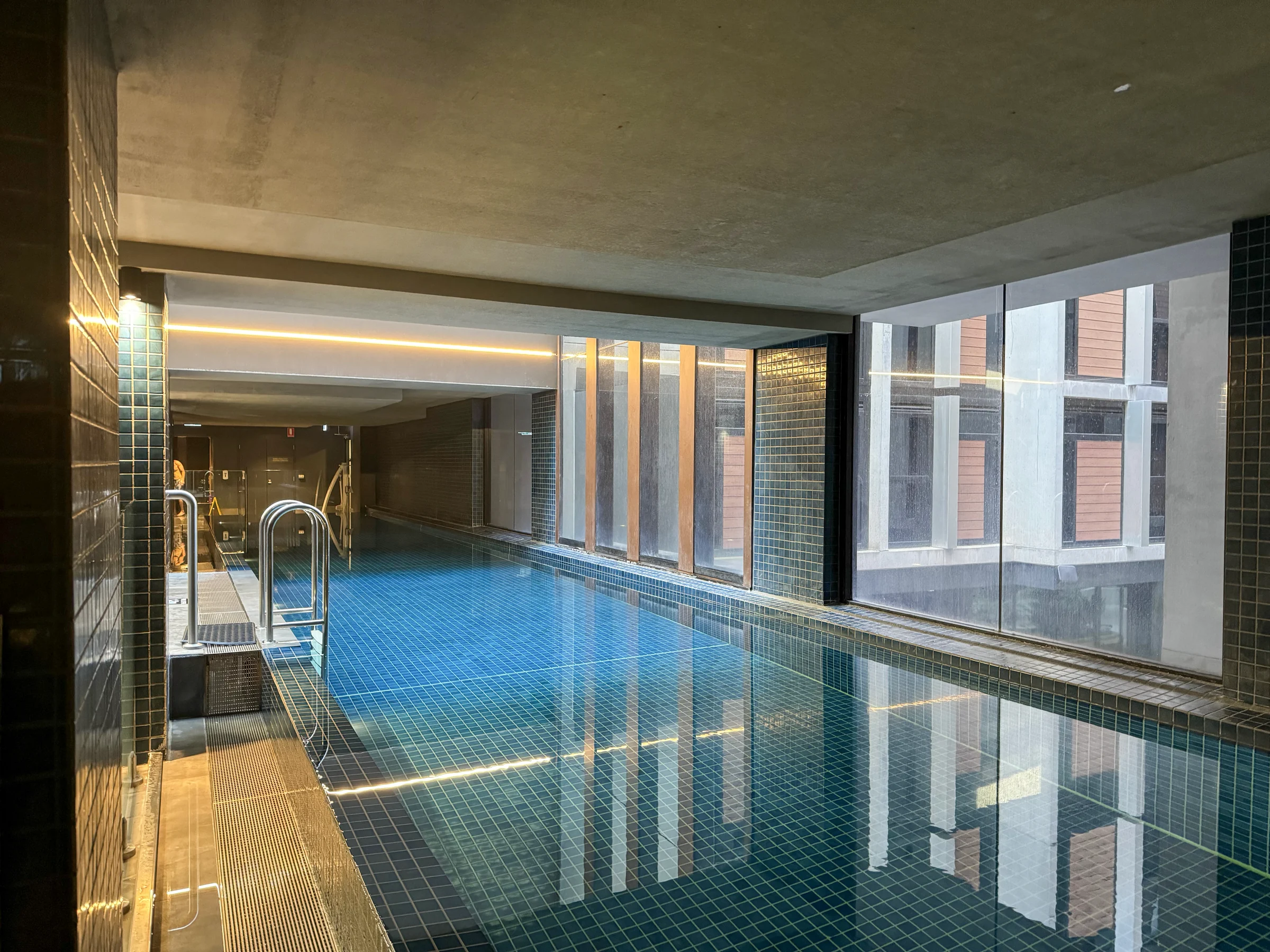 The indoor pool with light coming through the windows.
