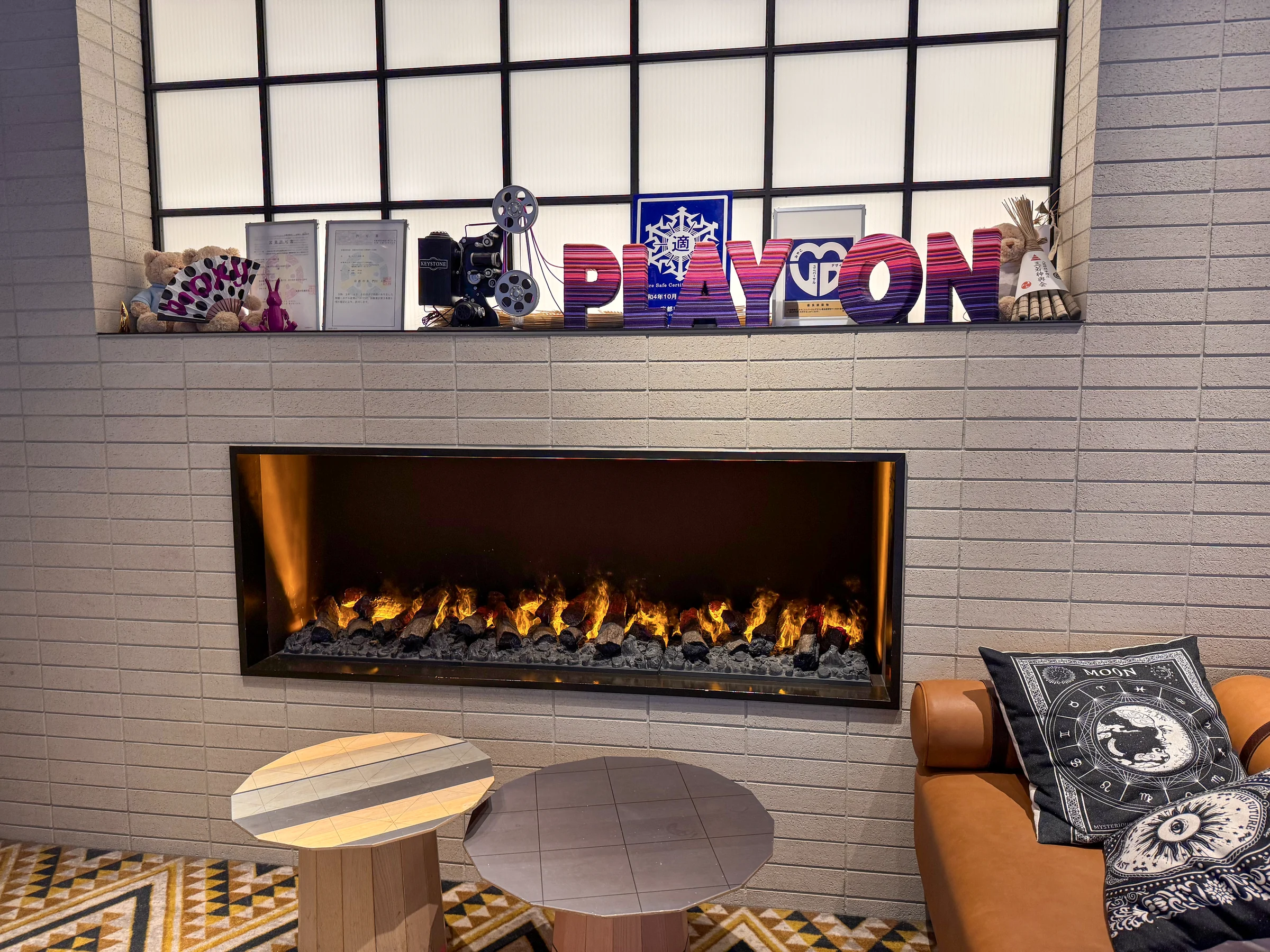 PLAY ON lettering and a decorative fireplace