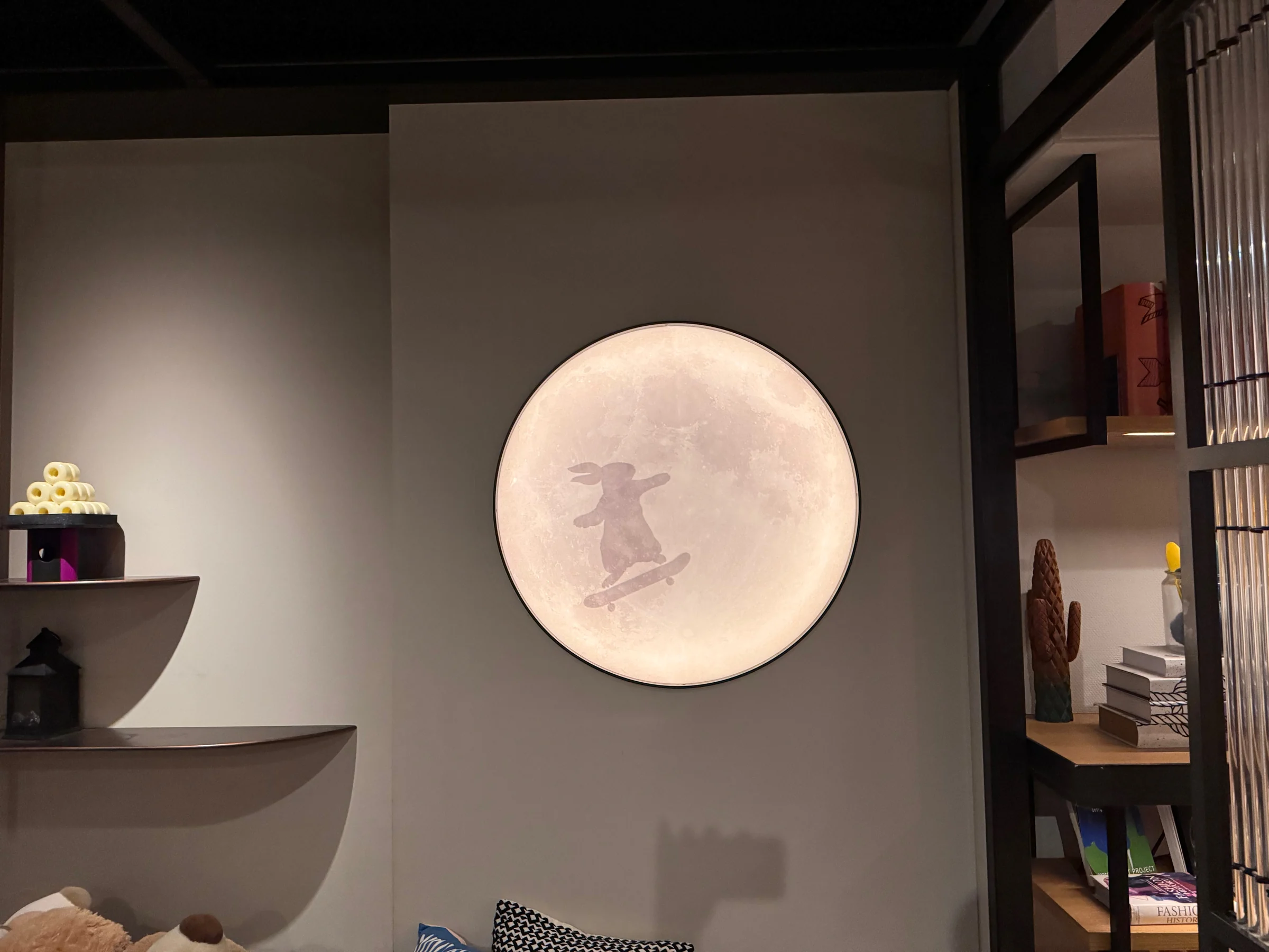 A round, moonlike light on the wall