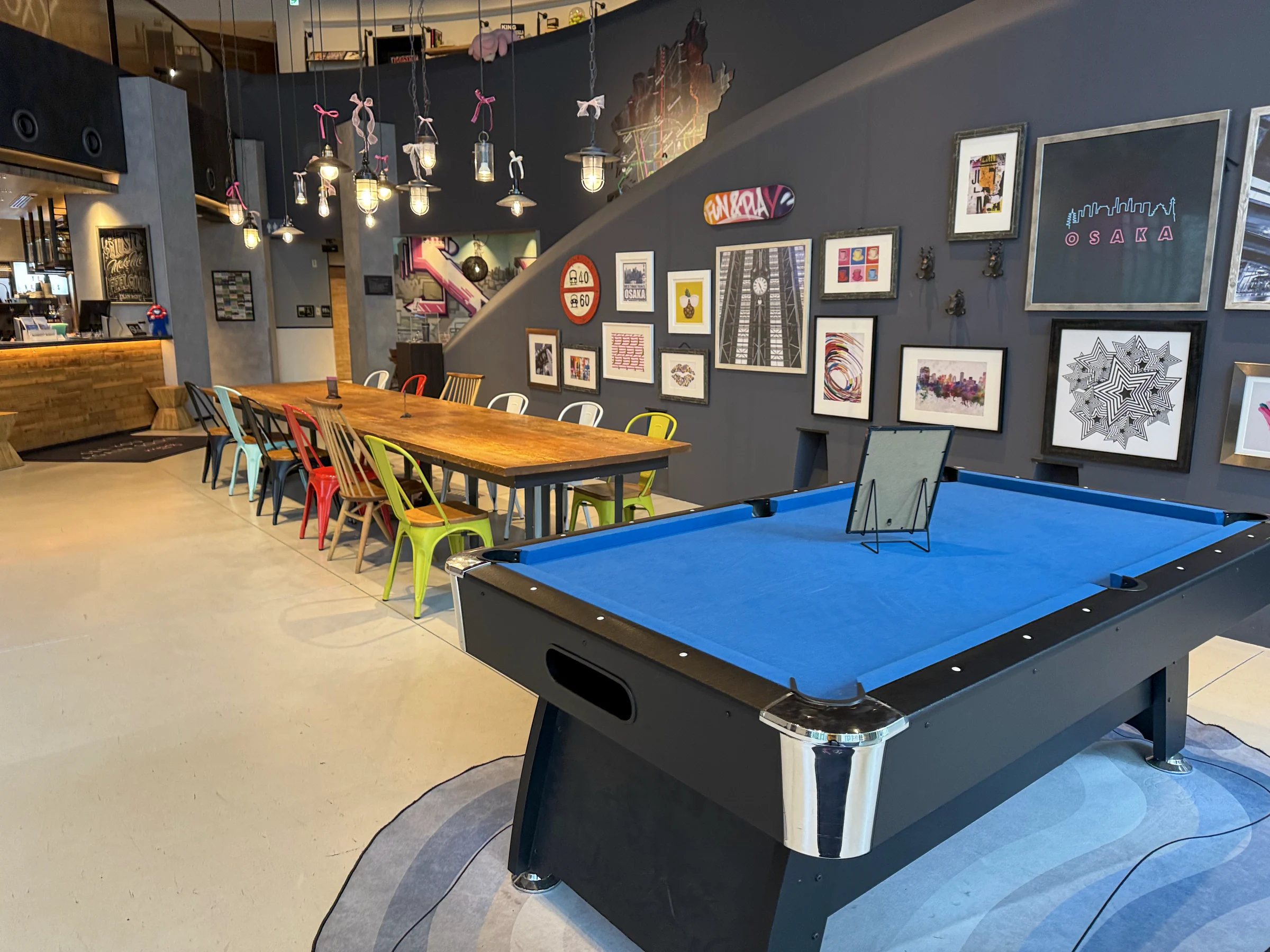The billiard table and colorful chairs.