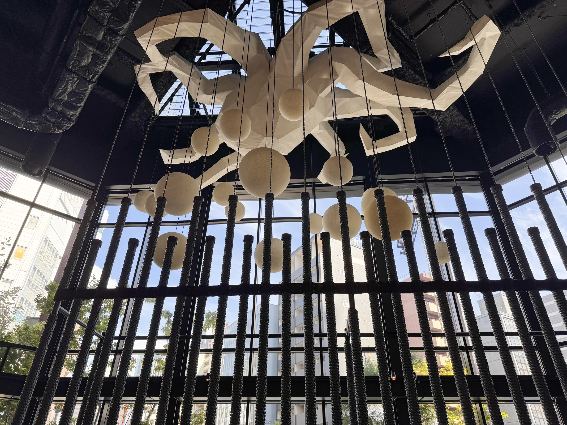 A giant octopus sculpture hanging by the window