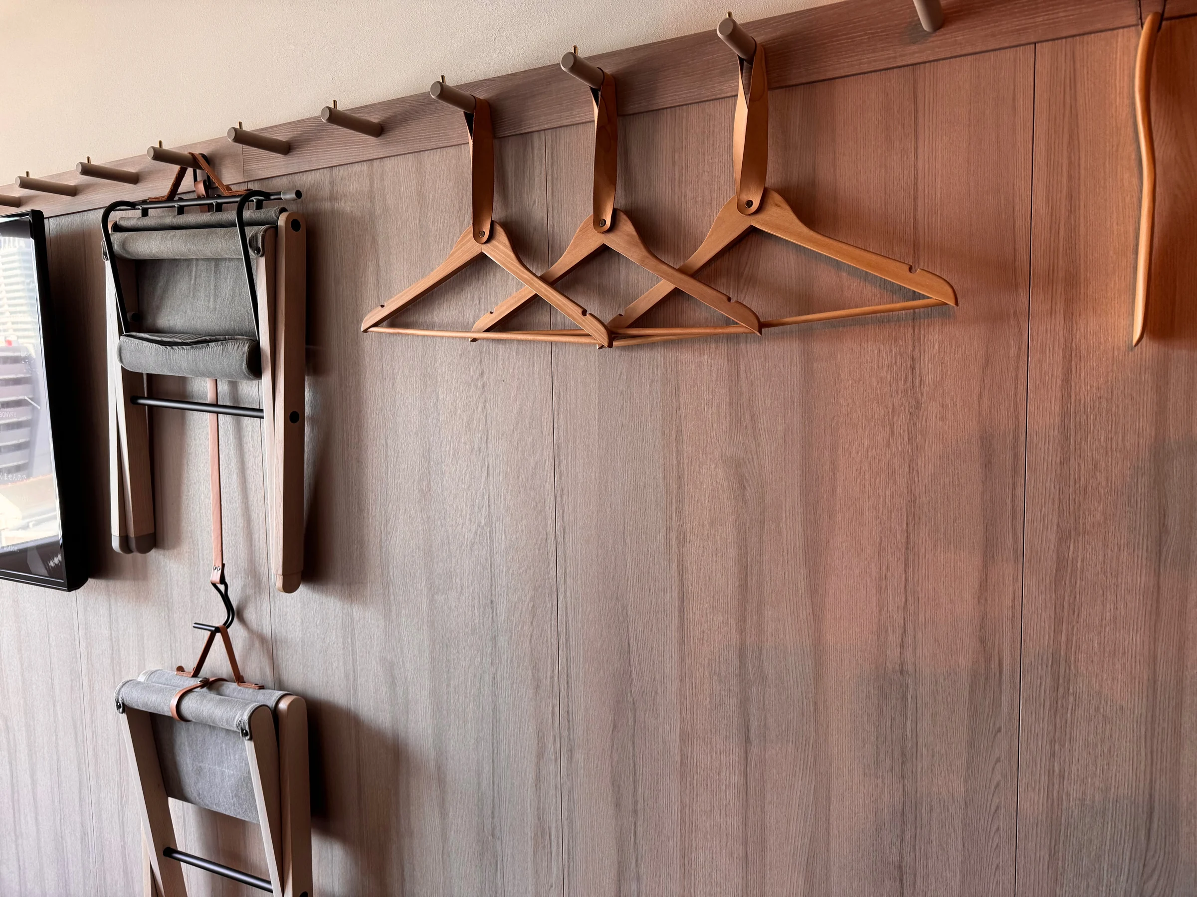 Hangers and a chair stored on the wall