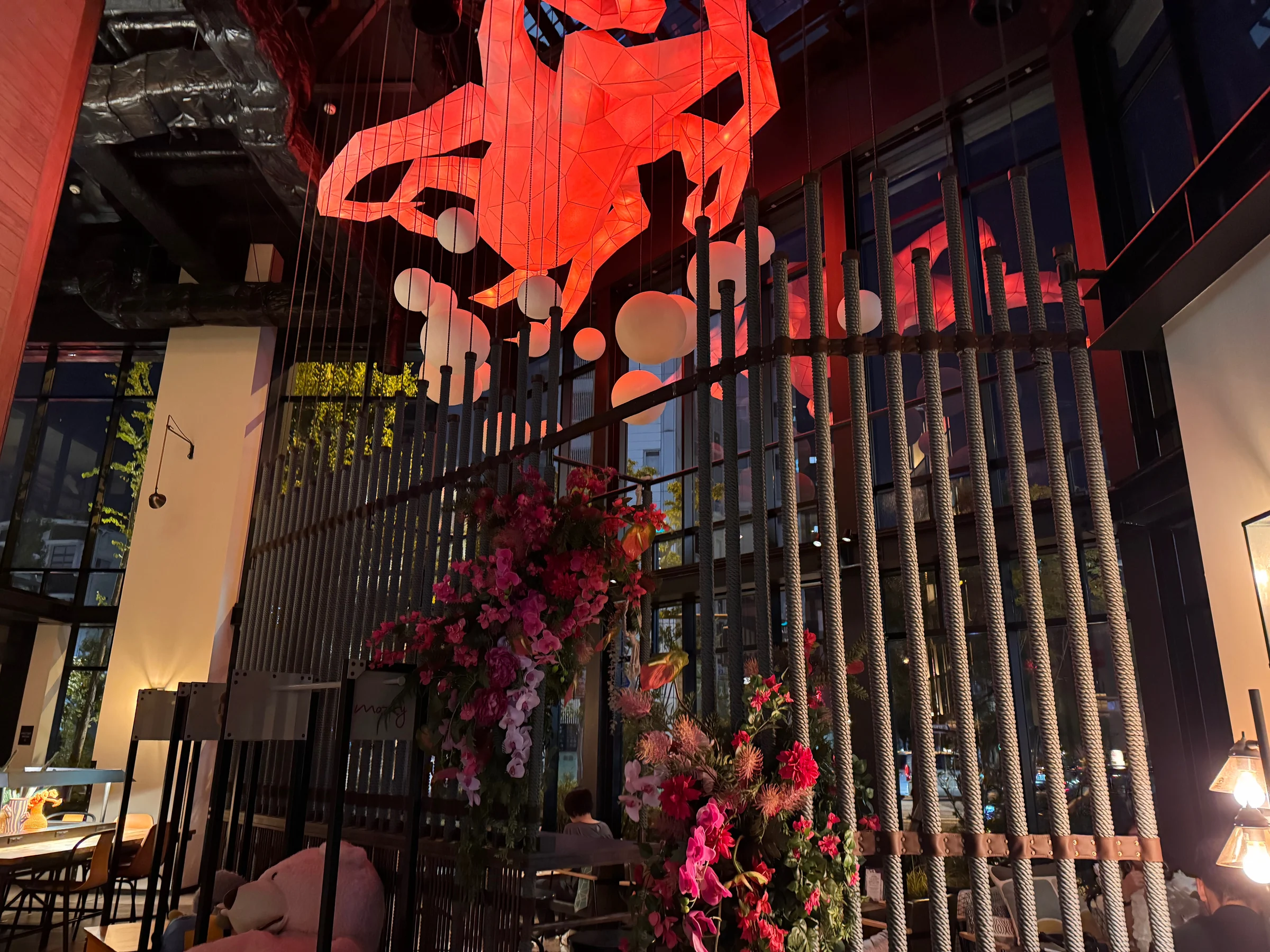 The octopus sculpture glowing red at night
