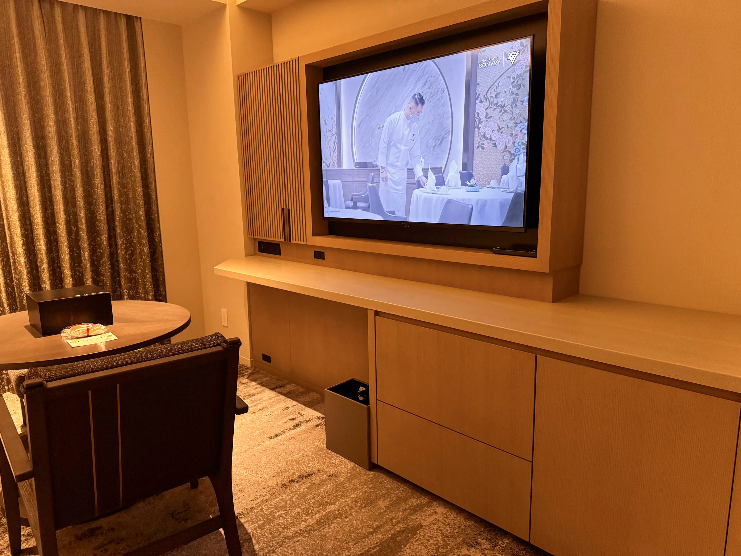 The wall-mounted television and counter below
