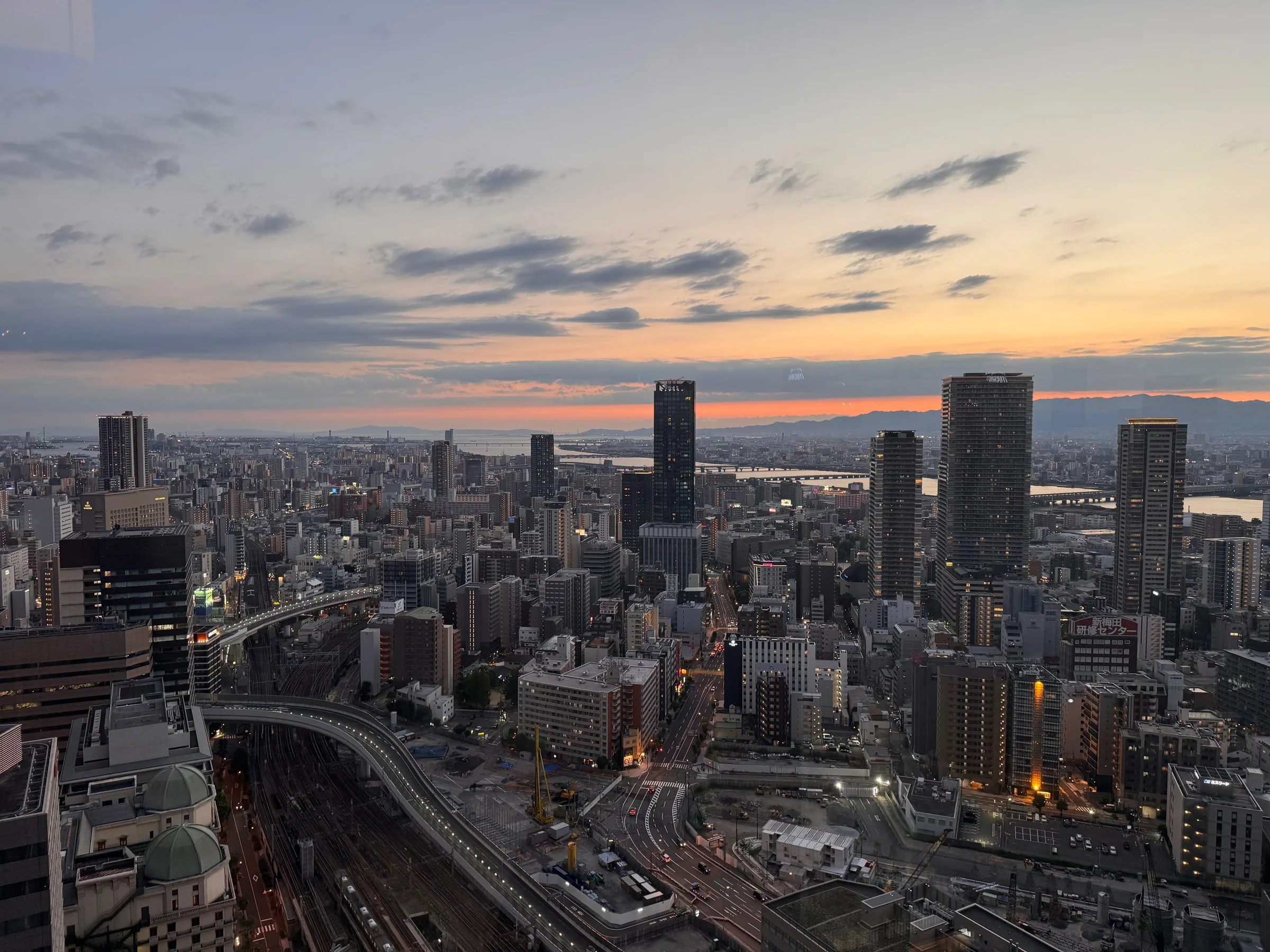 Osaka at dusk from the corner seat