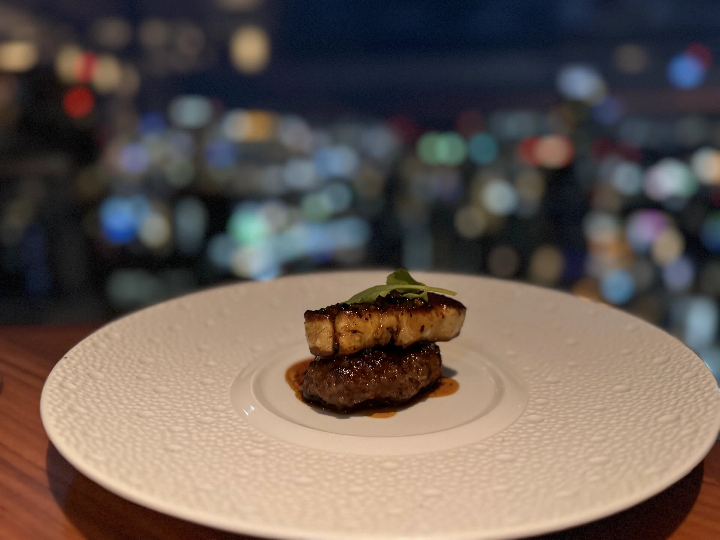 Foie gras and truffle risotto against the night view