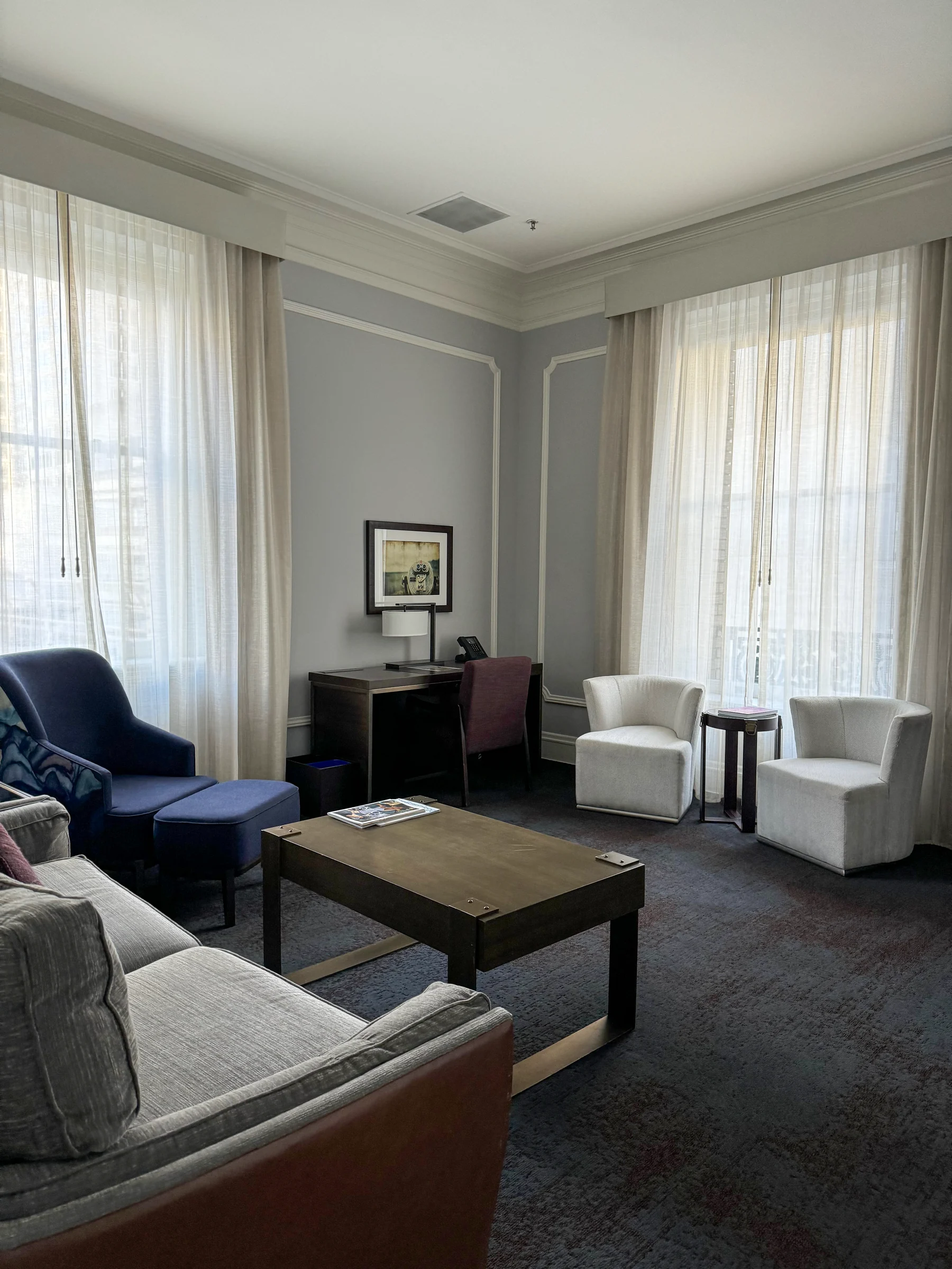 The suite living room, with a sofa and windows.