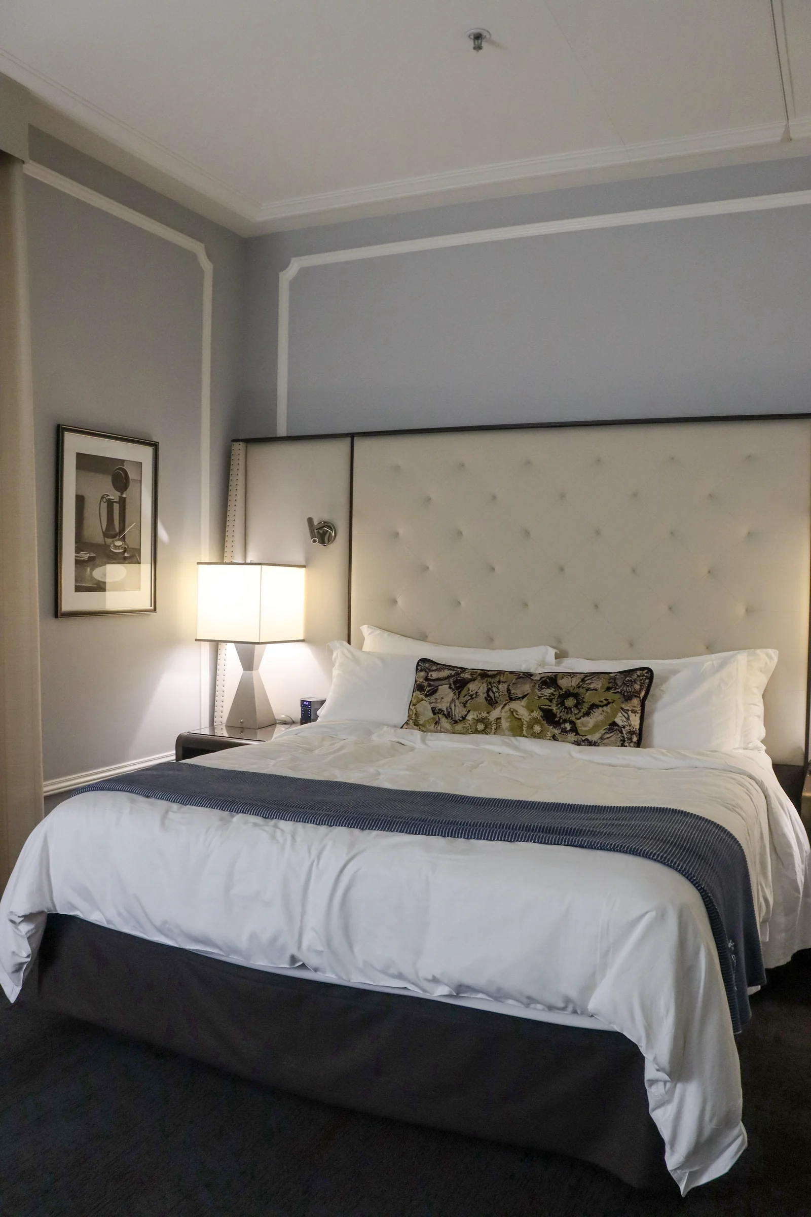 The bedroom at night, with bedside lighting.
