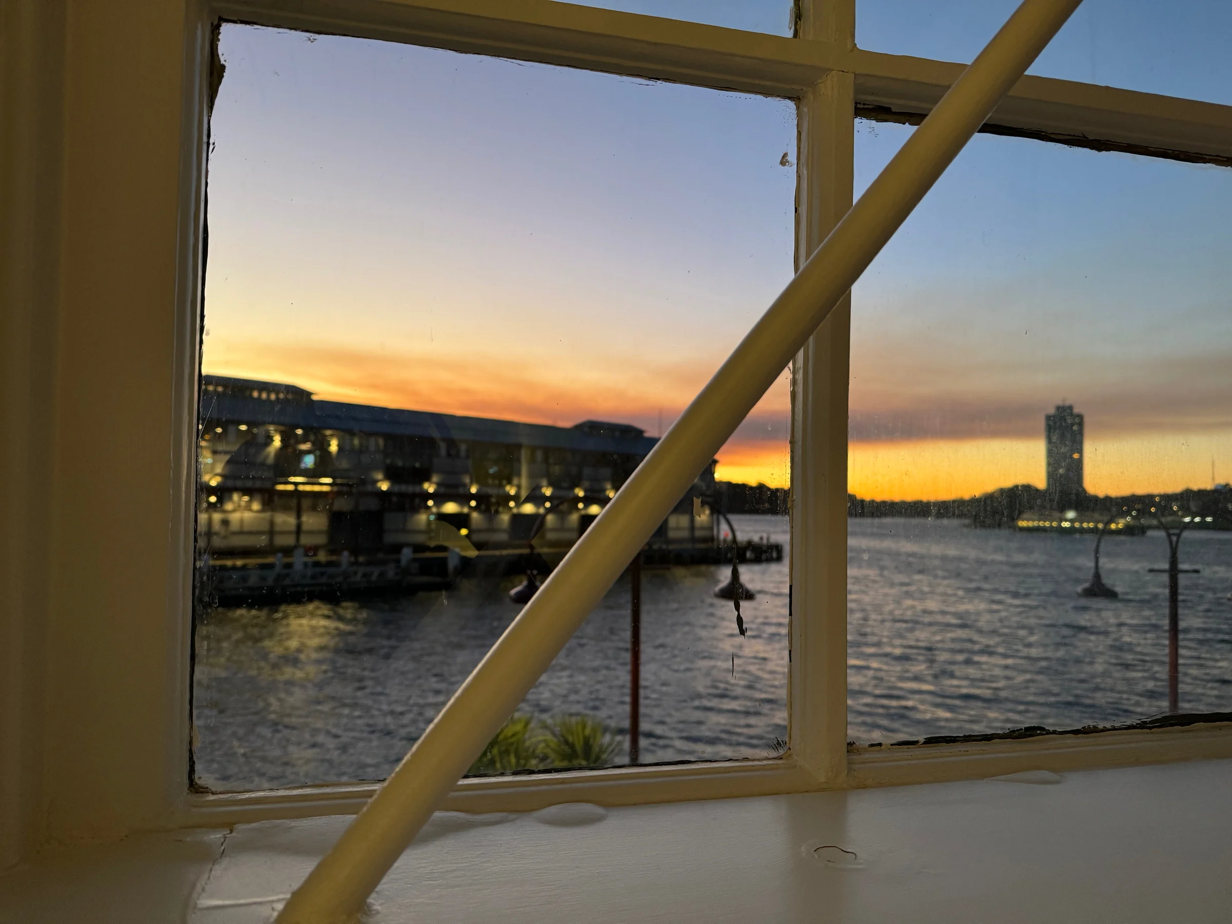 Waterfront and sunset beyond the window.