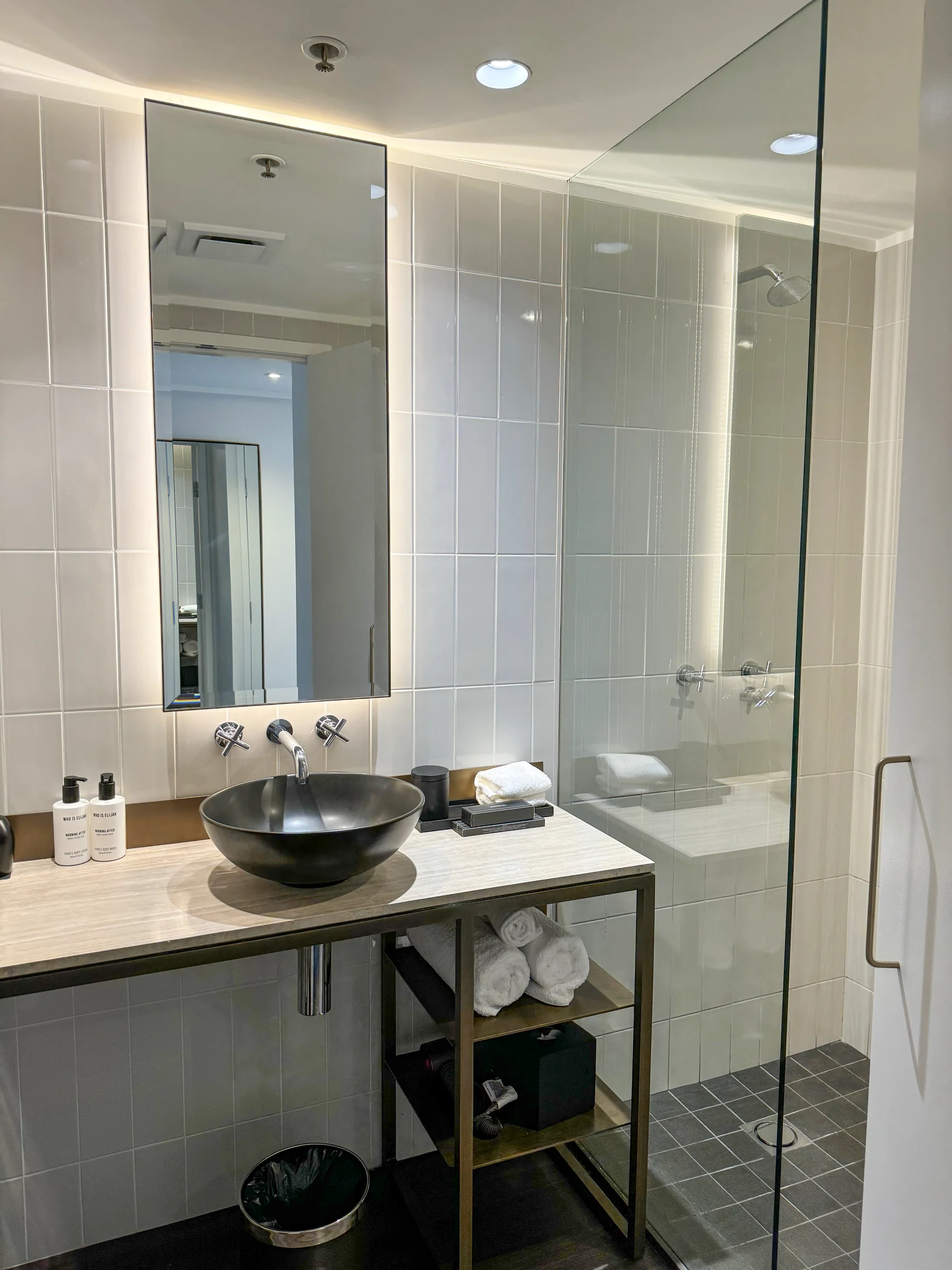 The bathroom with a vanity and shower.