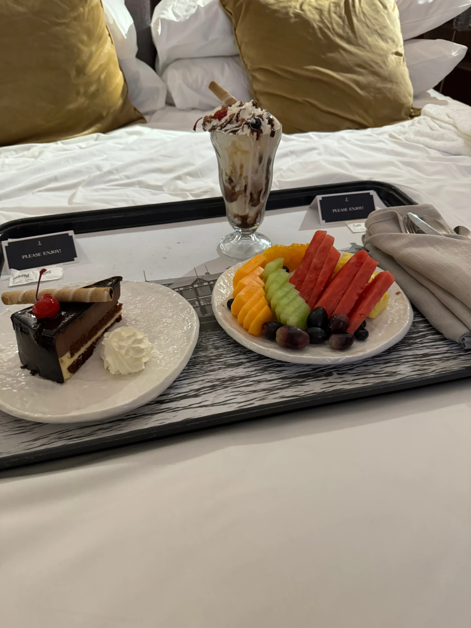 A plate of fruit and chocolates.