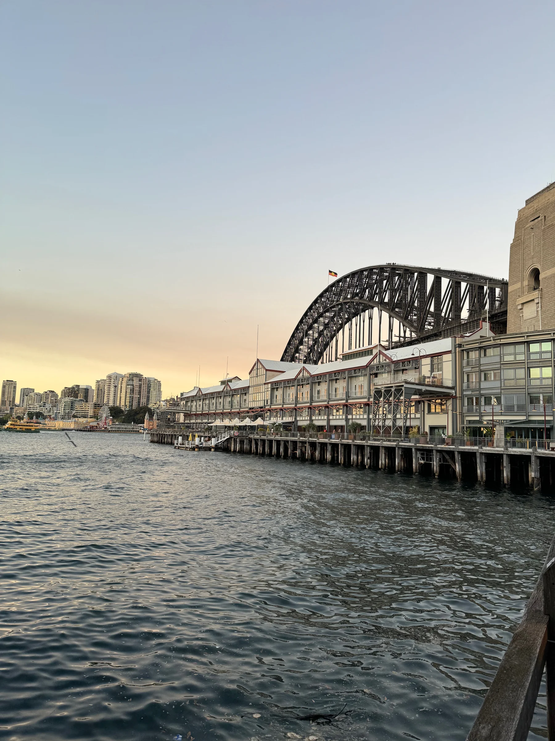 The waterfront and Harbour Bridge at dusk, seen from the pier at Pier One Sydney Harbour