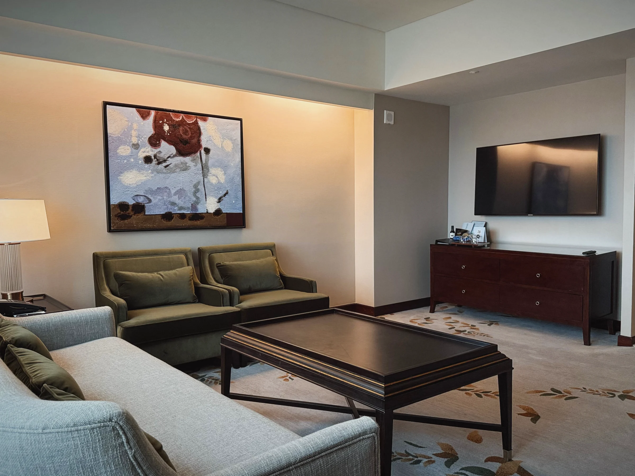 The living room with a sofa and armchairs